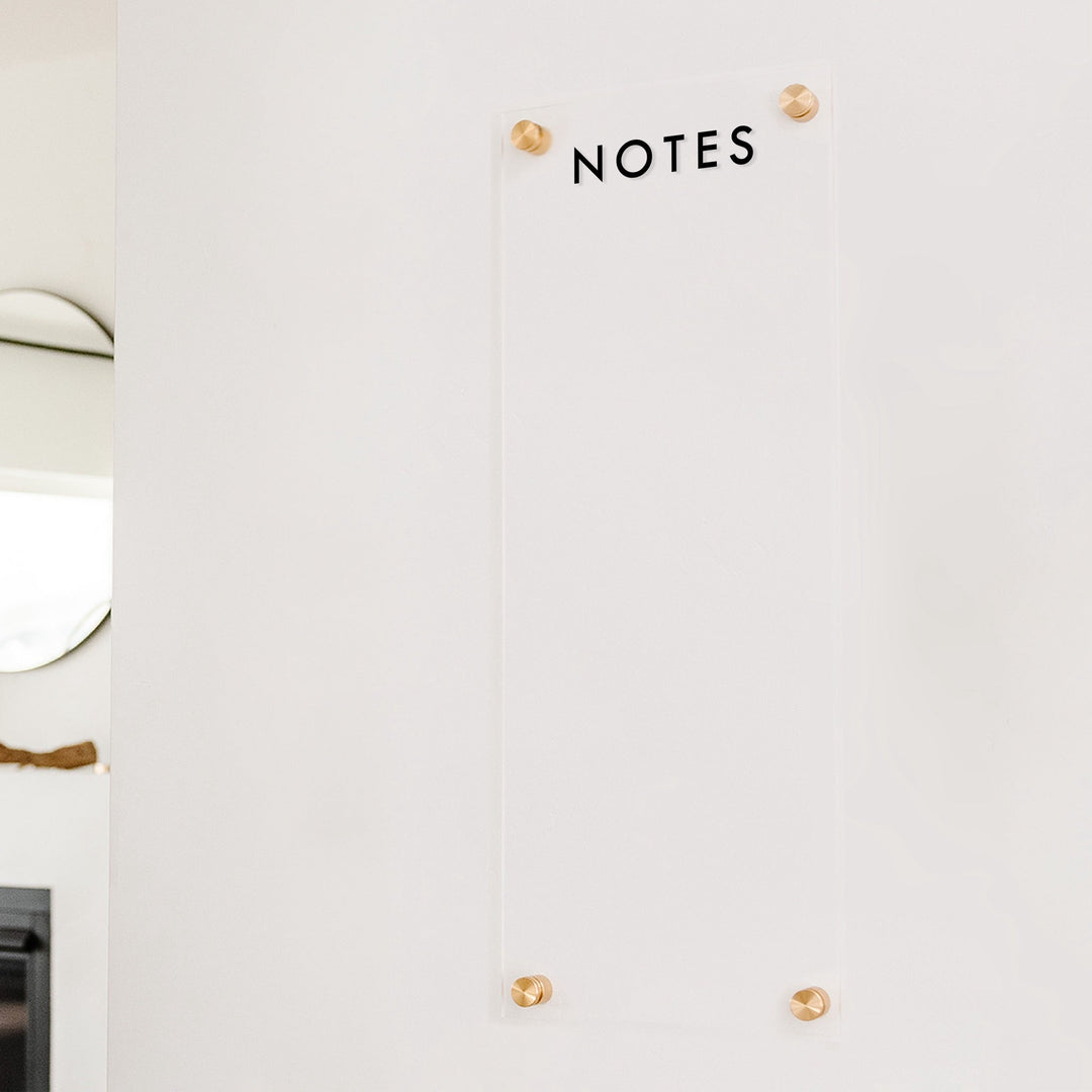 A dry-erase board made of clear acrylic with a custom title up top