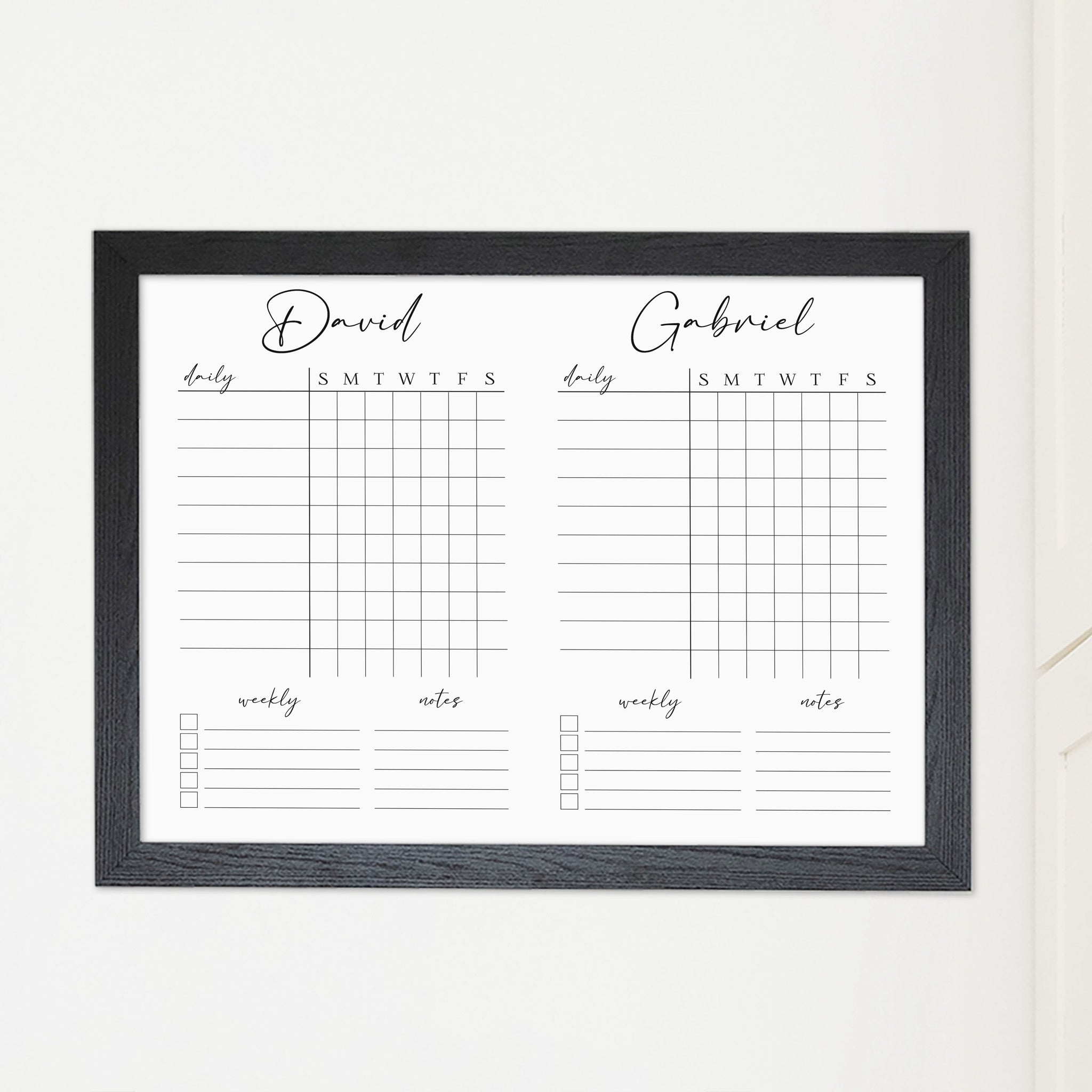 A framed whiteboard chore chart hanging on the wall