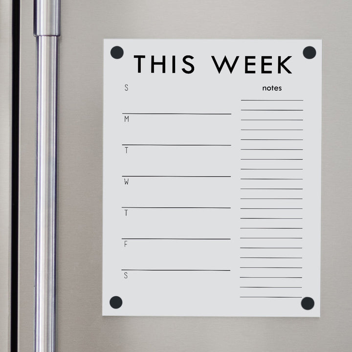 A Dry-erase weekly calender made of magnetic acrylic hanging on the fridge
