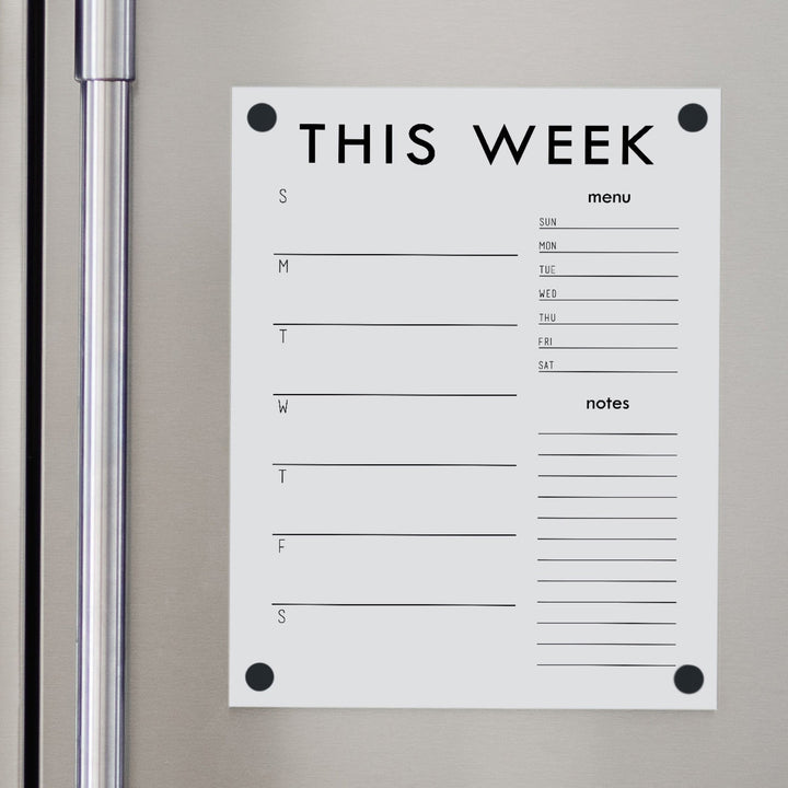A Dry-erase weekly calender made of magnetic acrylic hanging on the fridge
