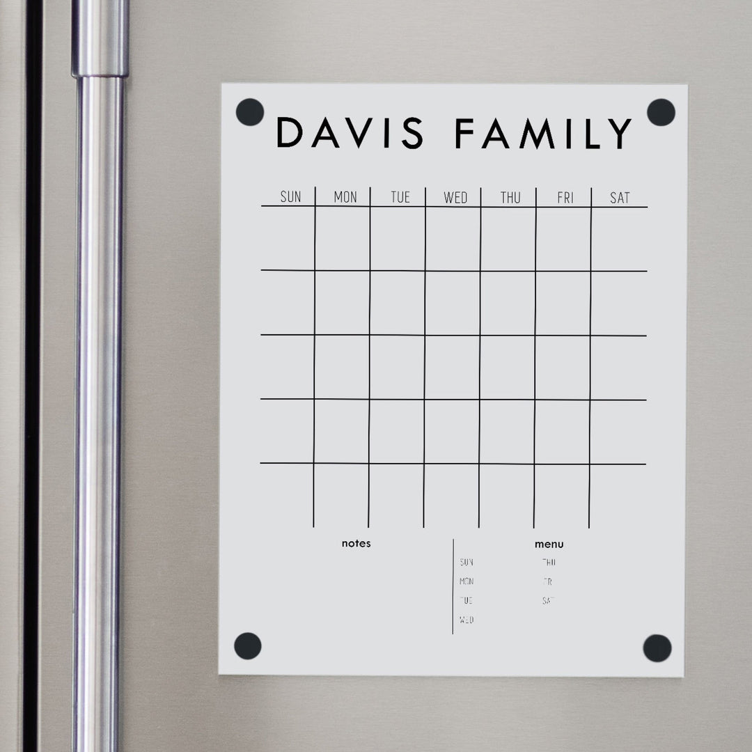 A Dry-erase monthly calender made of magnetic acrylic hanging on the fridge
