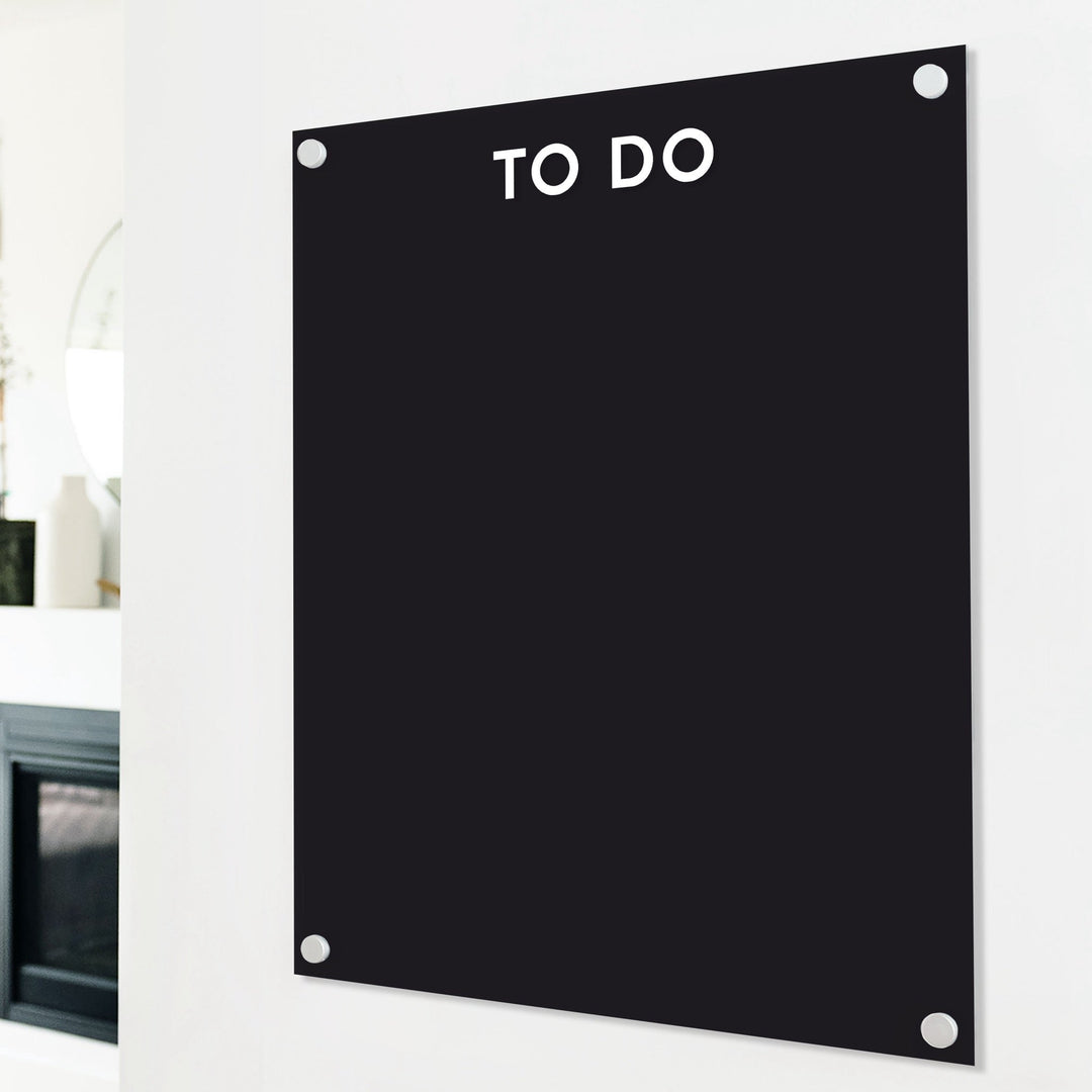 A dry-erase board made of clear acrylic with a custom title up top