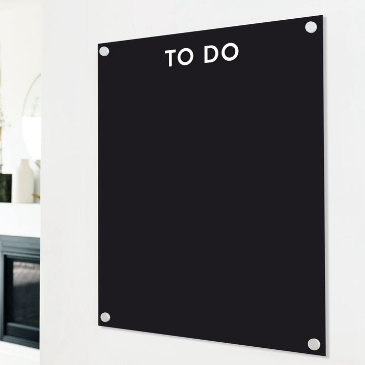 A dry-erase board made of clear acrylic with a custom title up top