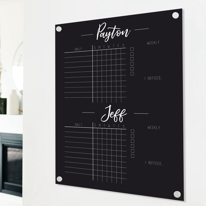 A Dry-erase acrylic chore chart hanging on the wall