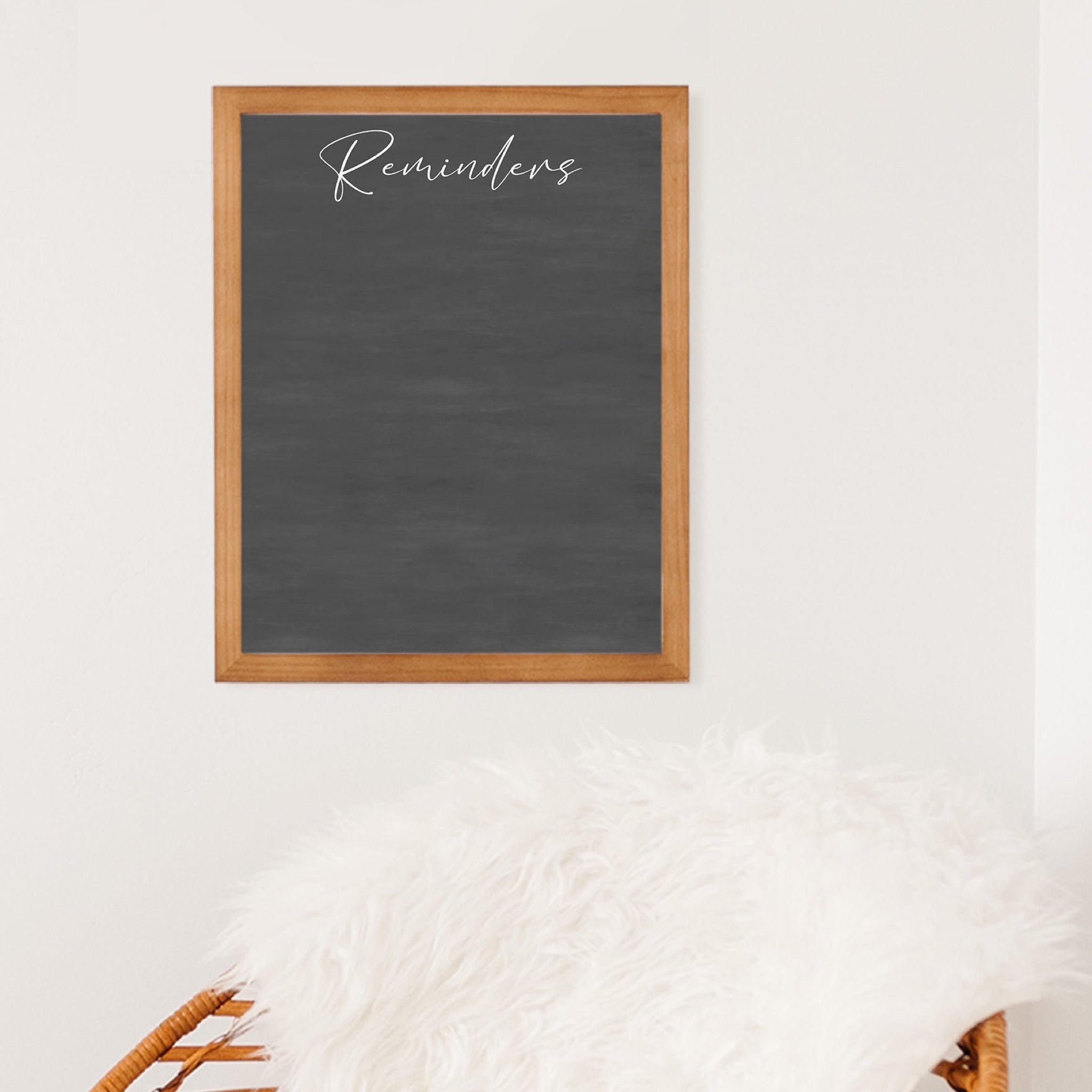 A framed dry-erase chalkboard calendar with a two month design format hanging on the wall