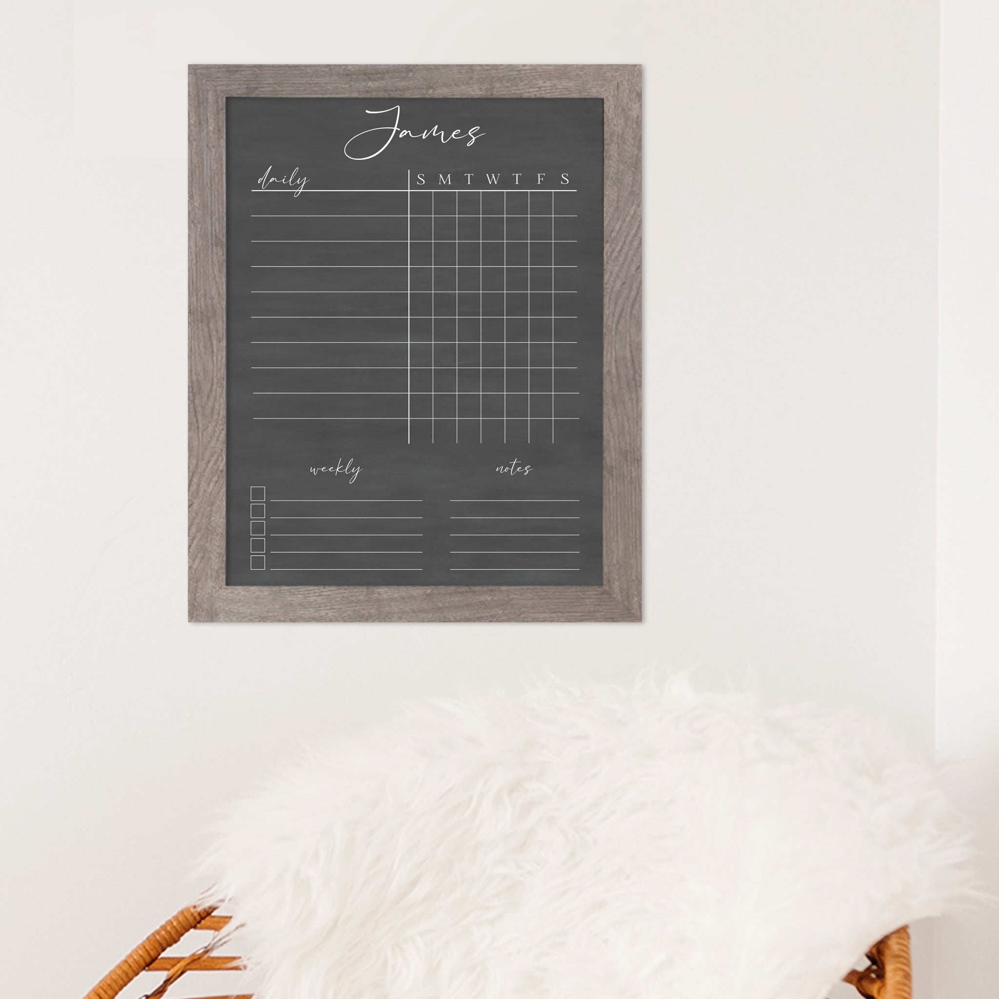 A framed dry-erase chore chart with a chalkboard look hanging on the wall