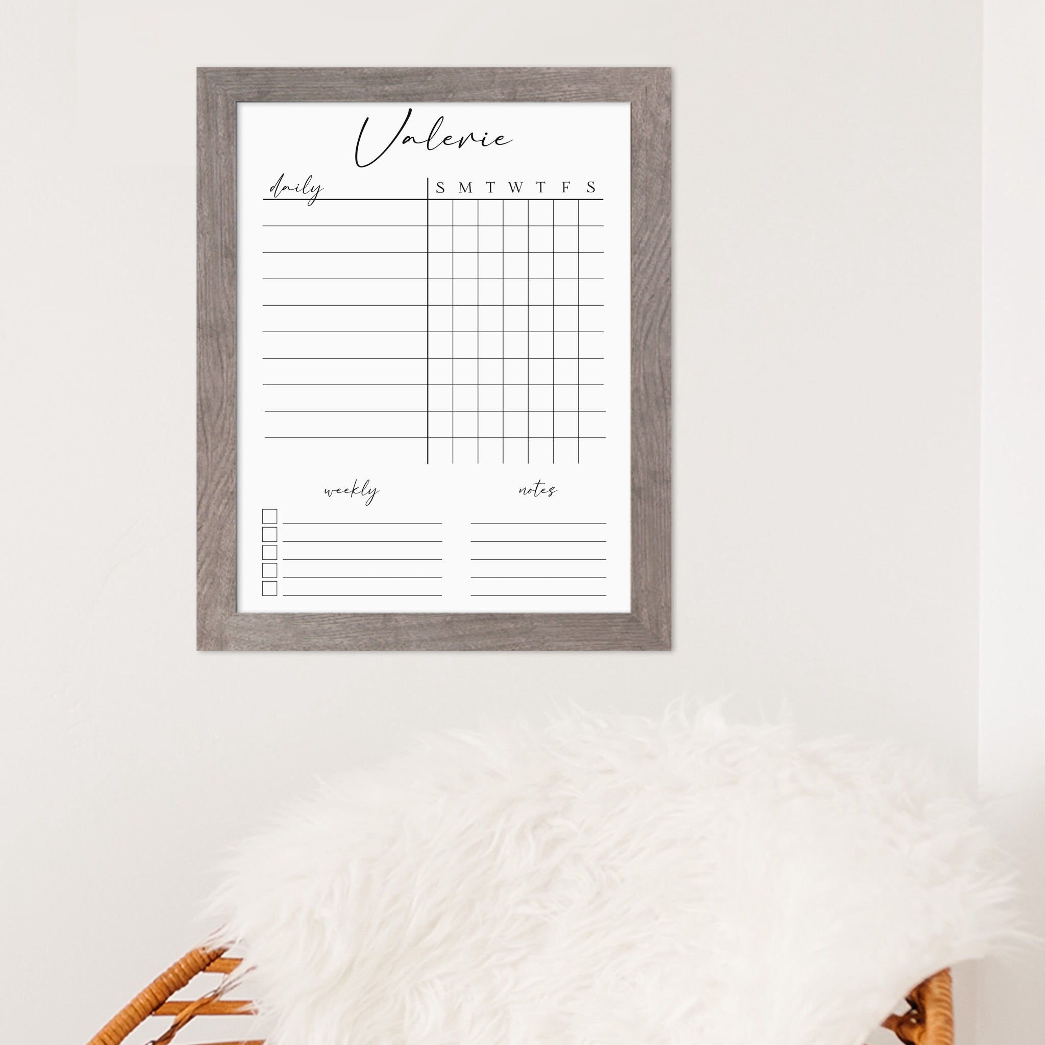 A framed whiteboard chore chart hanging on the wall
