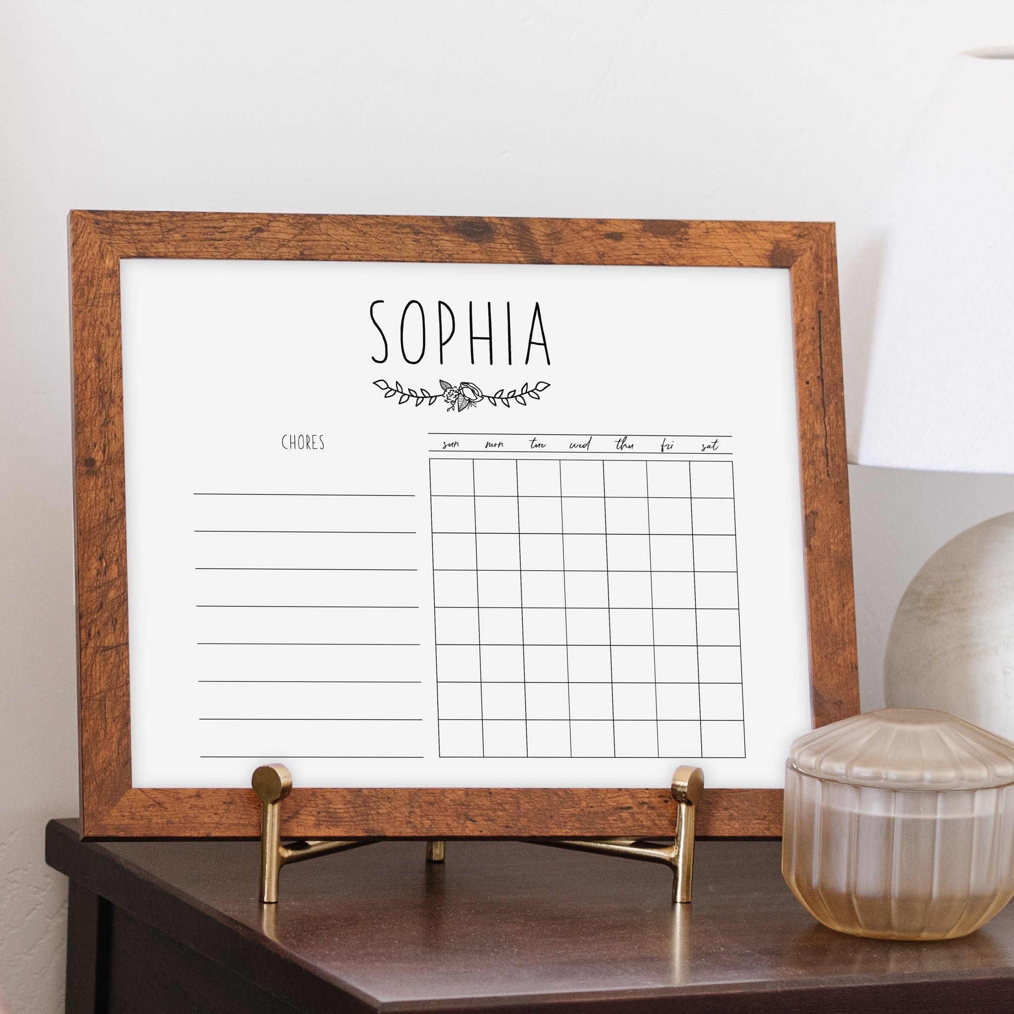 A framed whiteboard monthly calender hanging on the wall