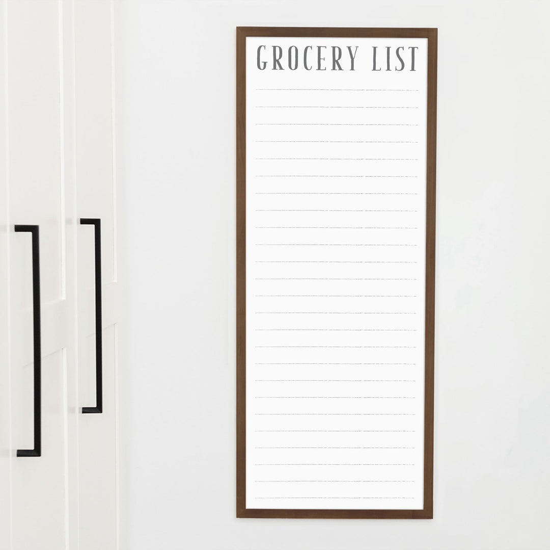 A framed whiteboard to do list hanging on the wall