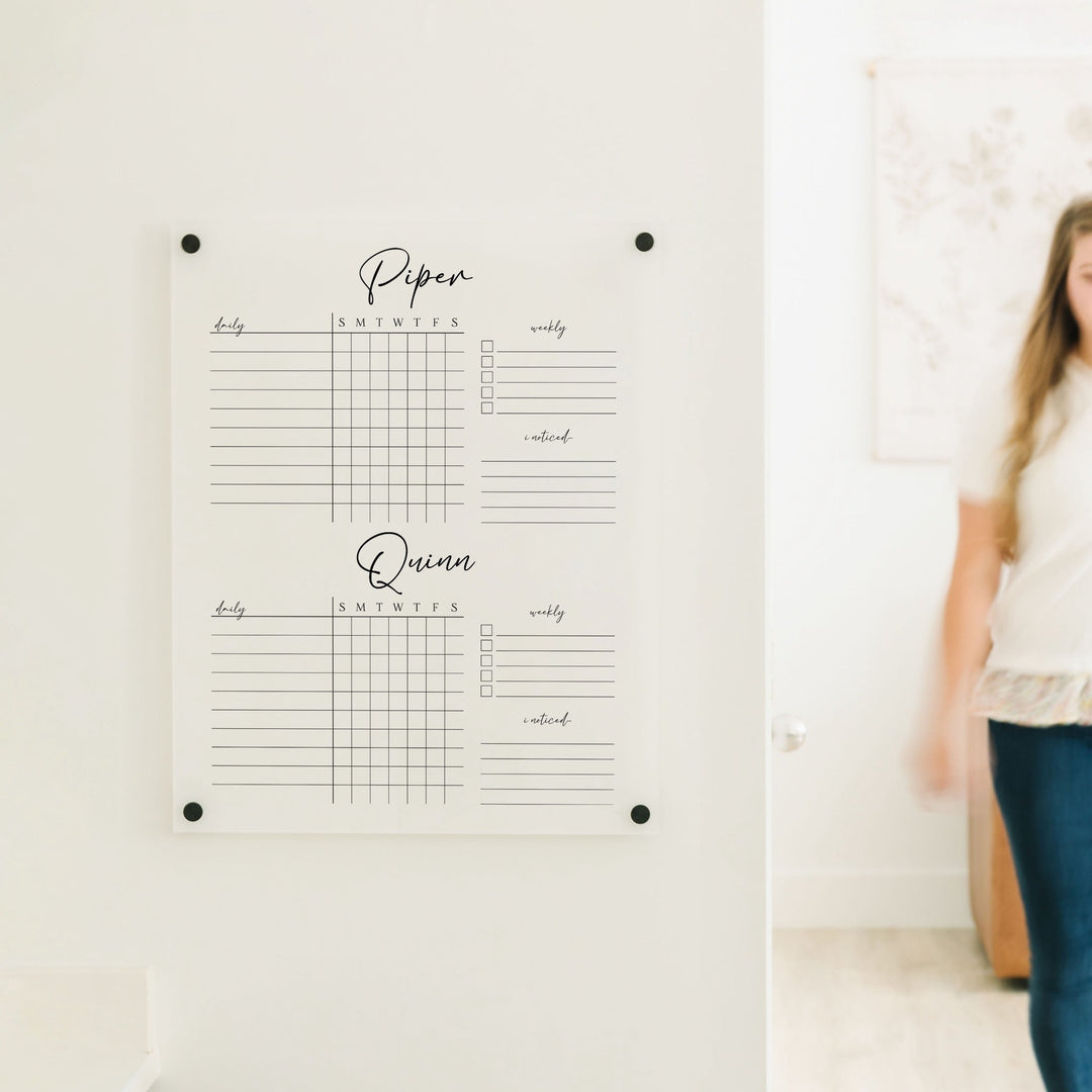 A Dry-erase acrylic chore chart hanging on the wall