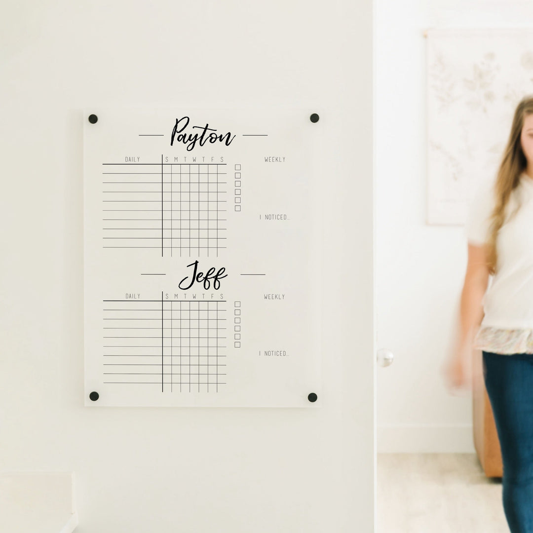 A Dry-erase acrylic chore chart hanging on the wall