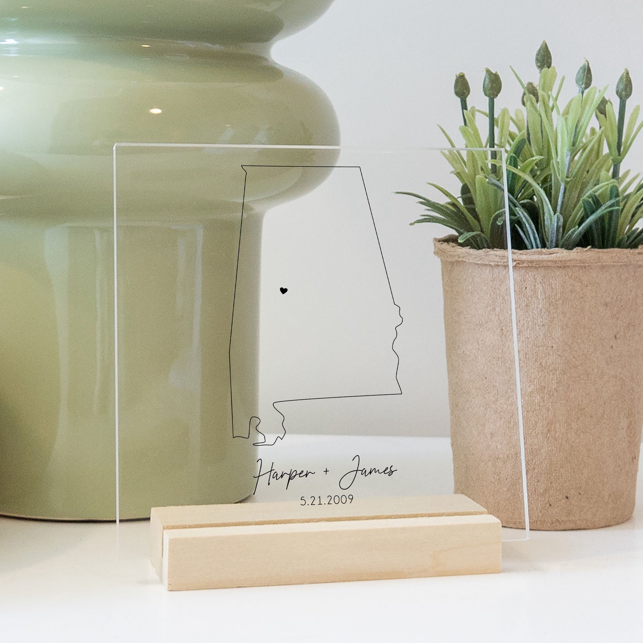 Clear acrylic sign with wood base featuring an Alabama location and custom text