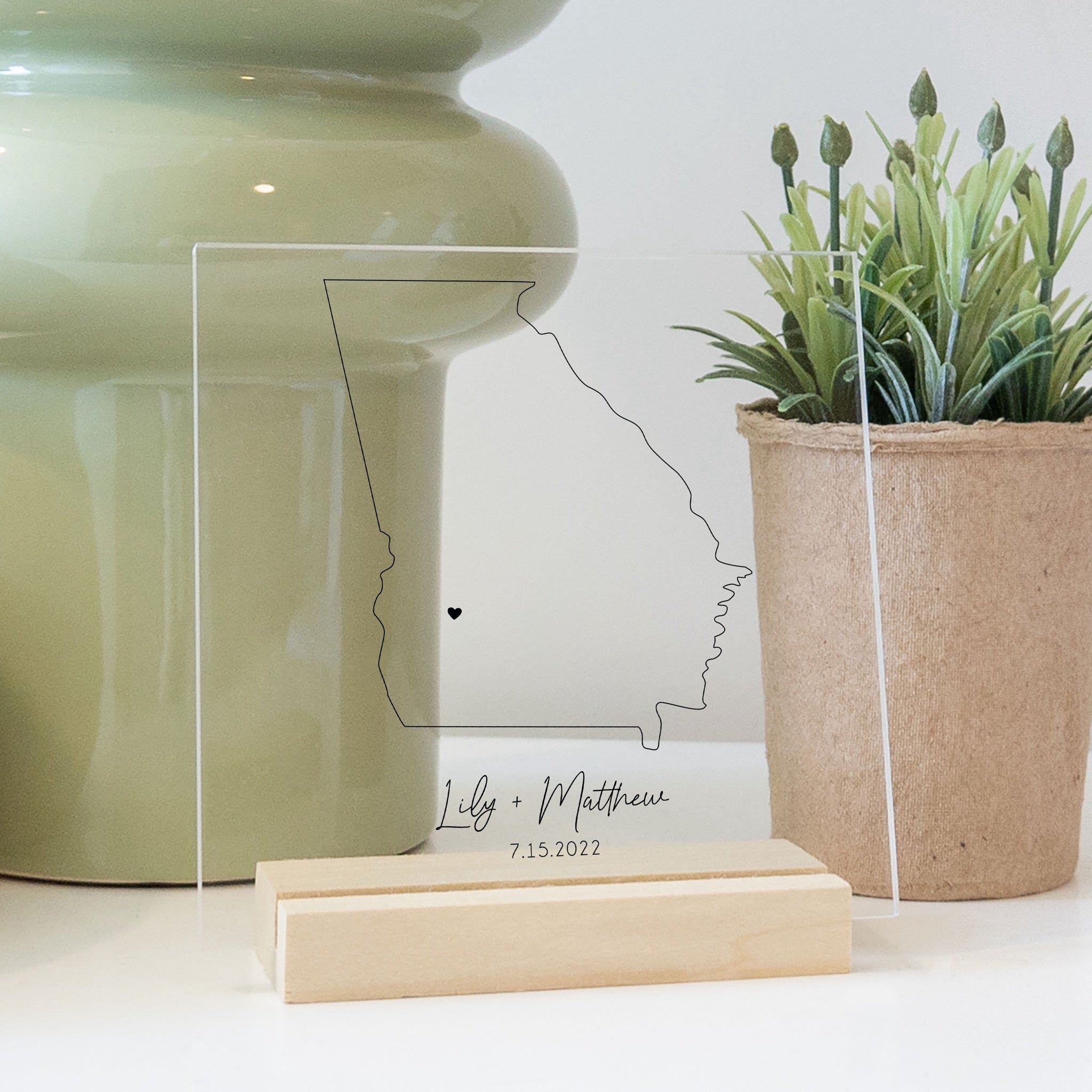 Clear acrylic sign with wood base featuring a Georgia location and custom text