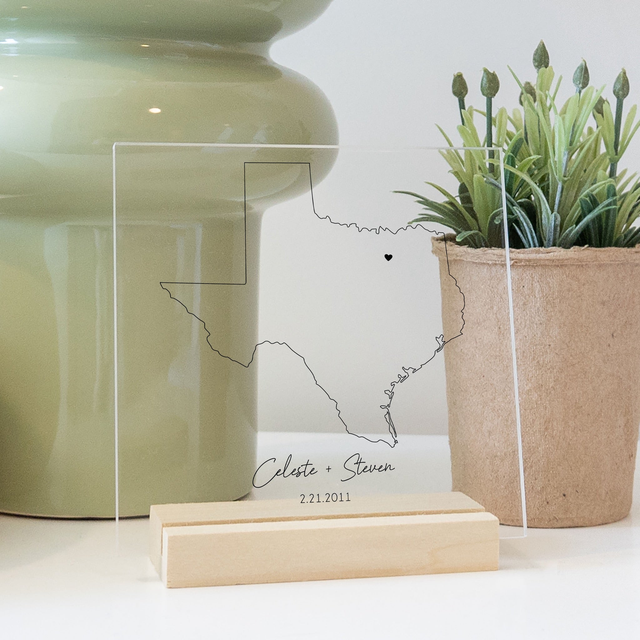 Clear acrylic sign with wood base featuring a Texas location and custom text