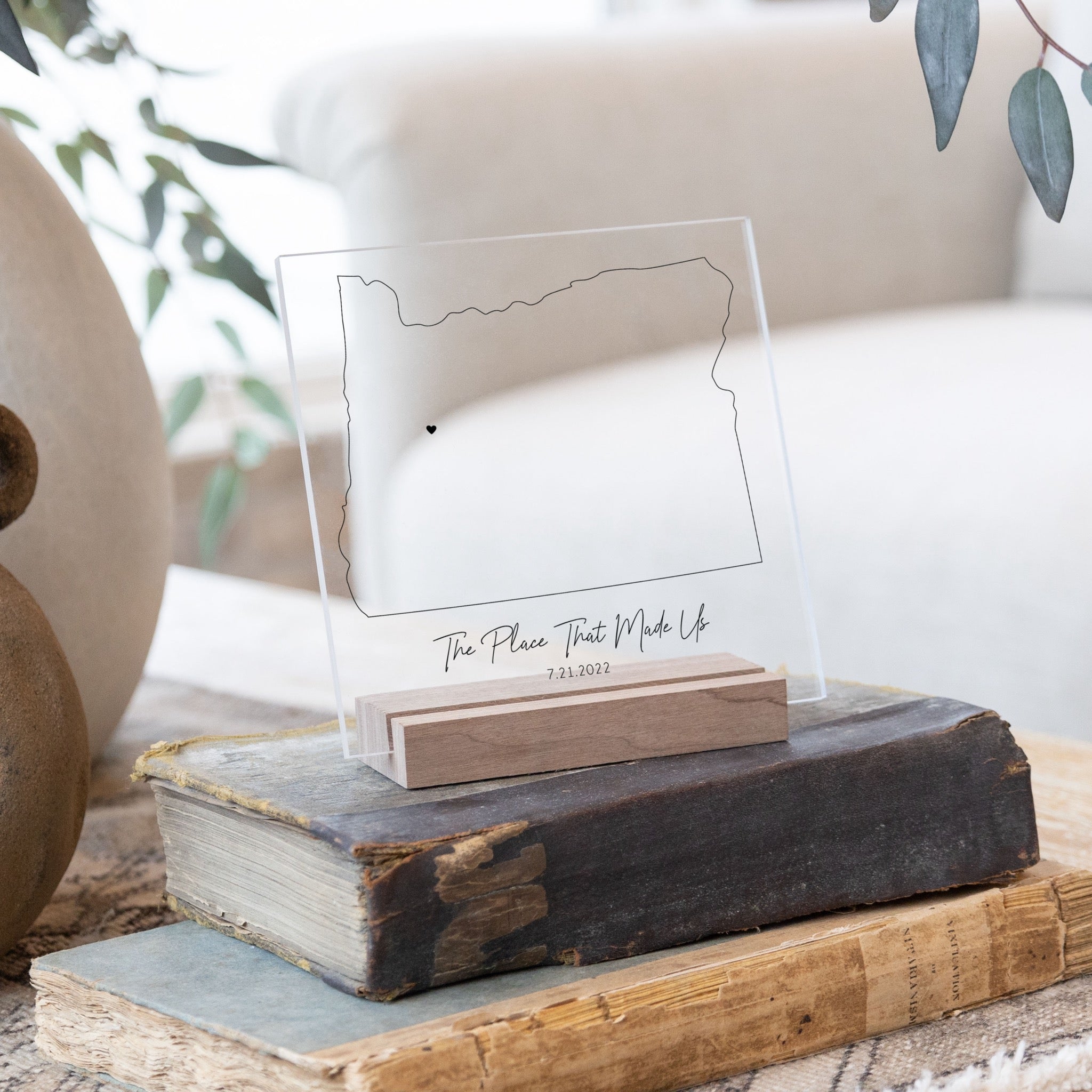 Clear acrylic sign with wood base featuring an Oregon location and custom text