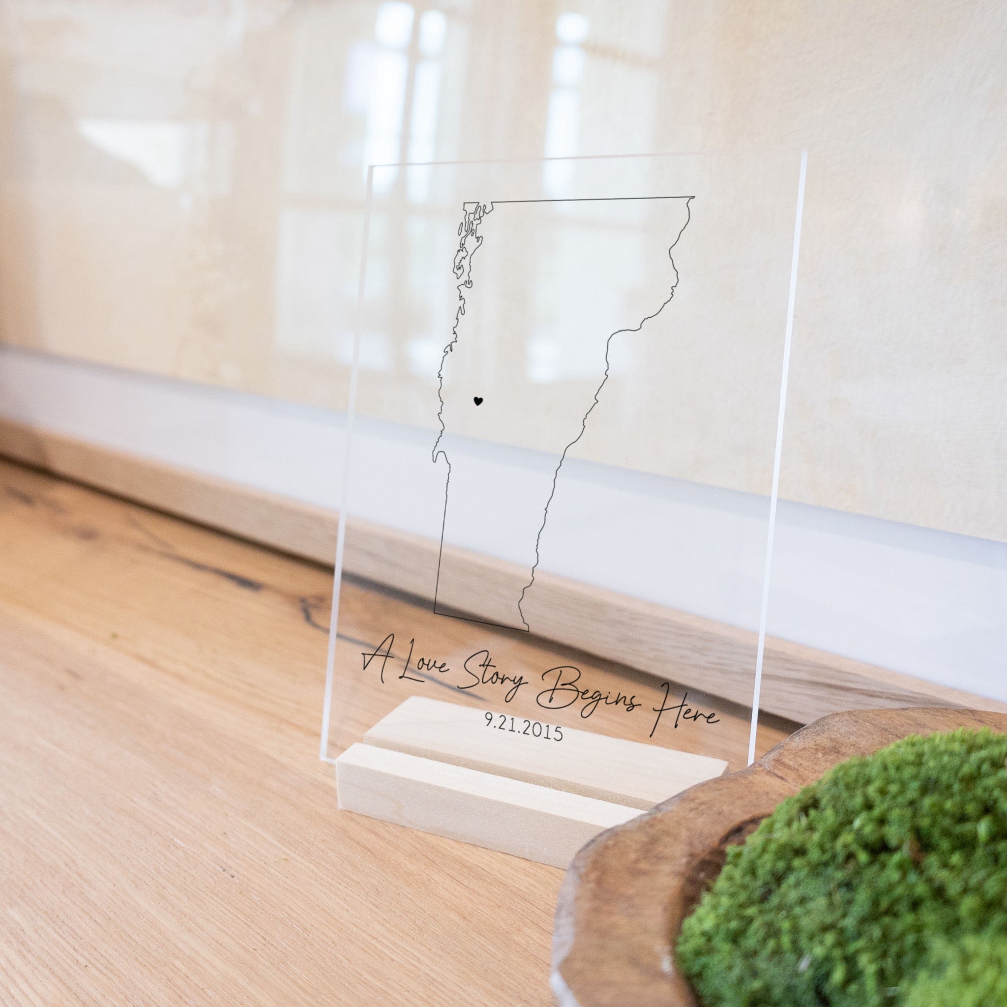 Clear acrylic sign with wood base featuring a Vermont location and custom text