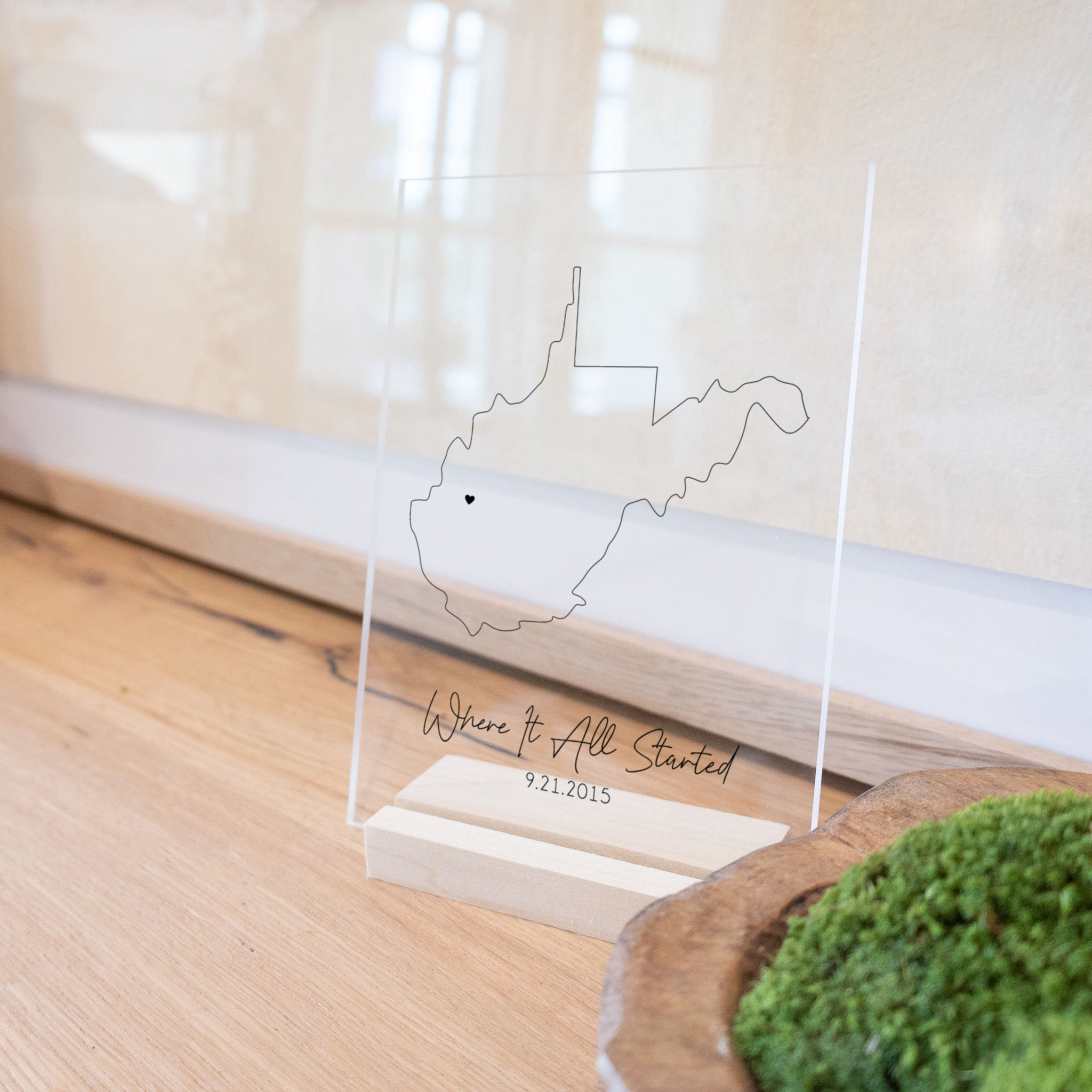 Clear acrylic sign with wood base featuring a West Virginia location and custom text