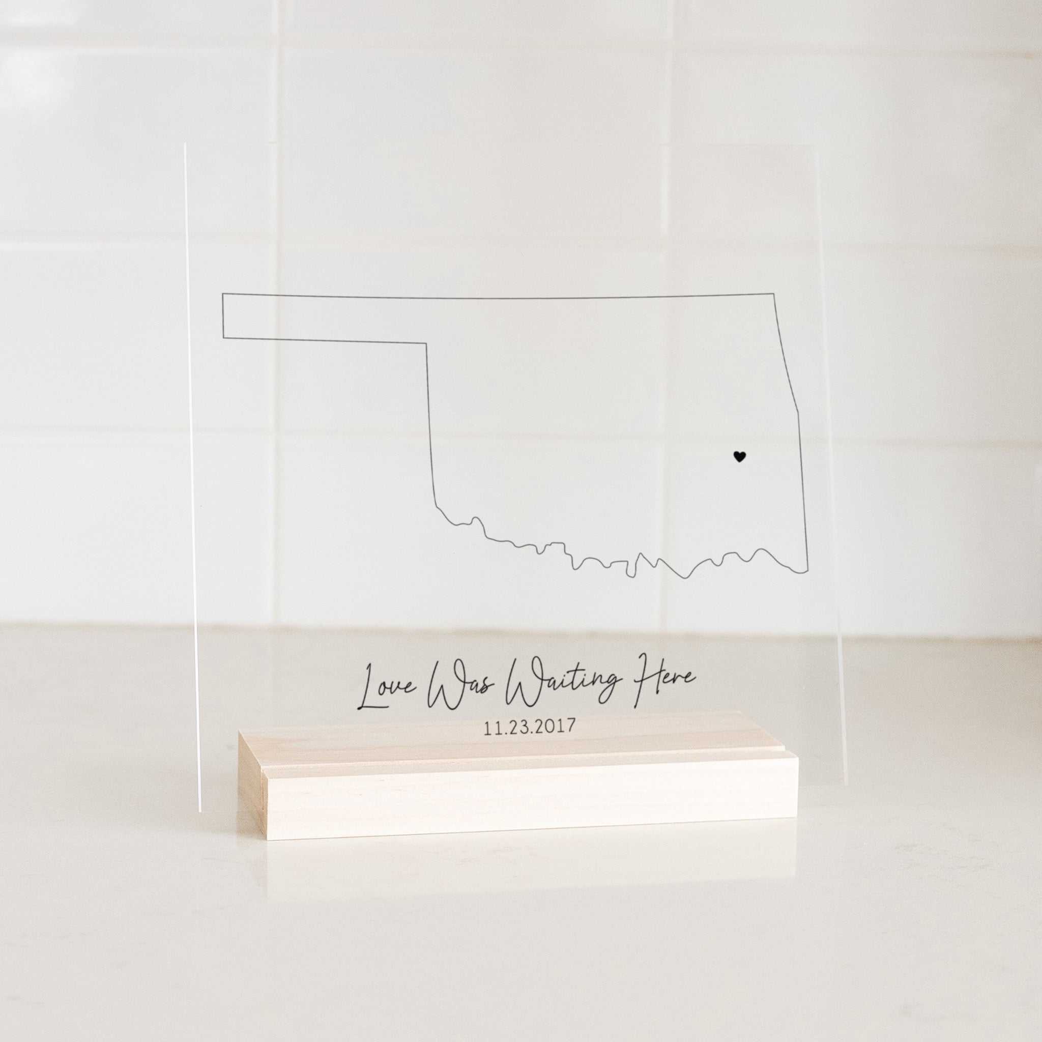 Clear acrylic sign with wood base featuring an Oklahoma location and custom text