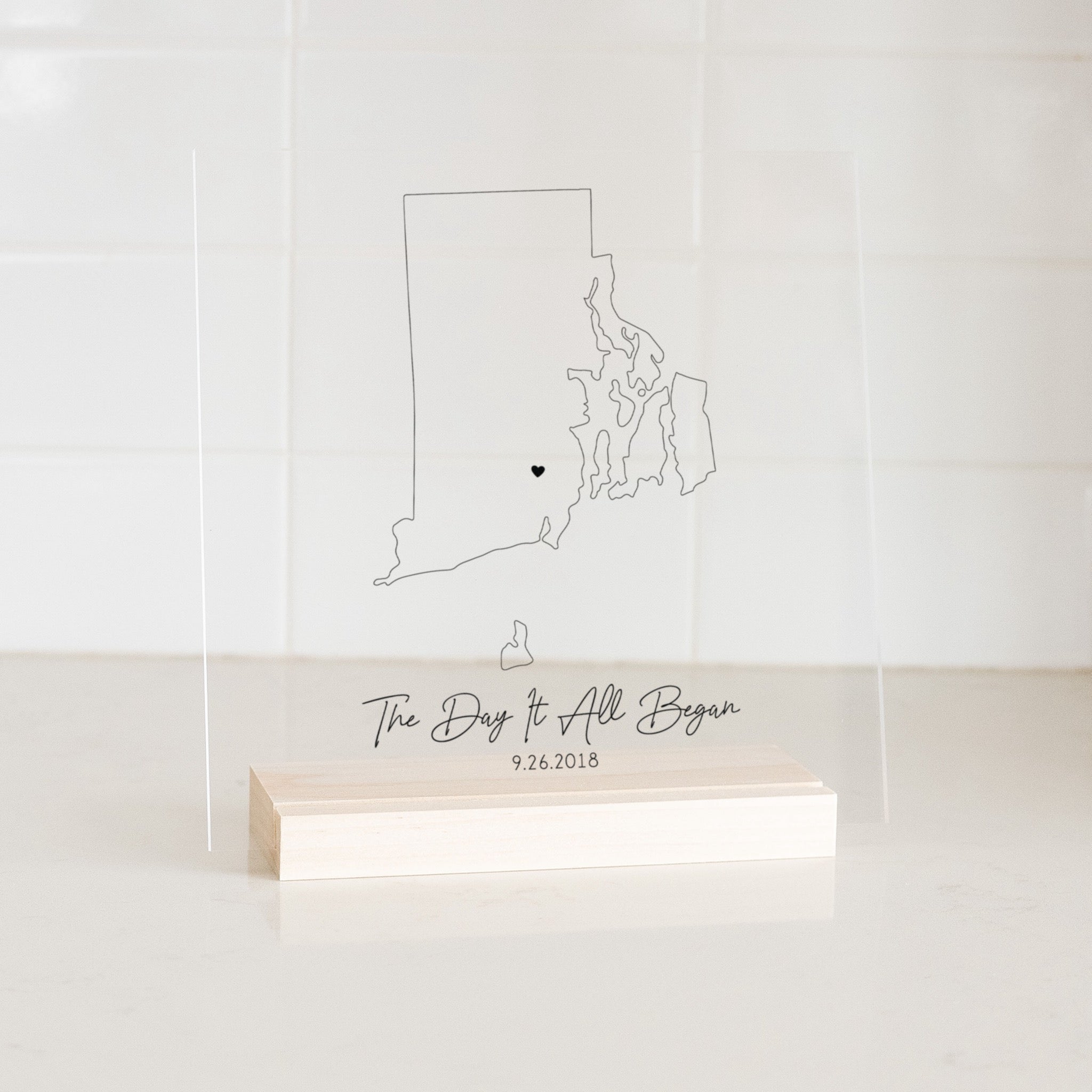 Clear acrylic sign with wood base featuring a Rhode Island location and custom text