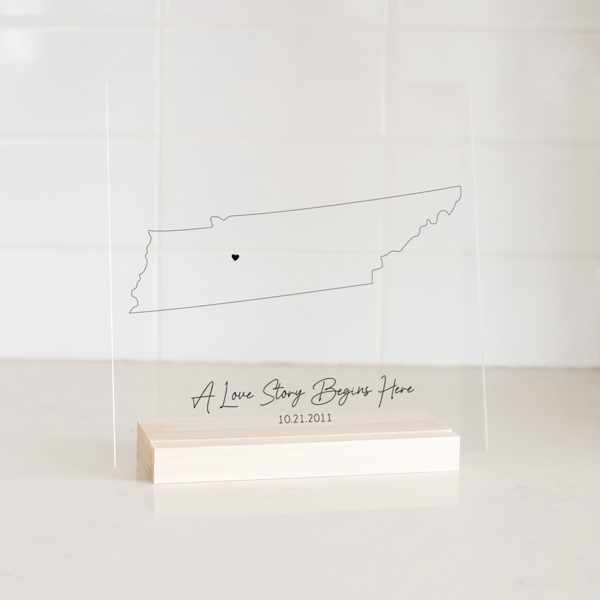 Clear acrylic sign with wood base featuring a Tennessee location and custom text