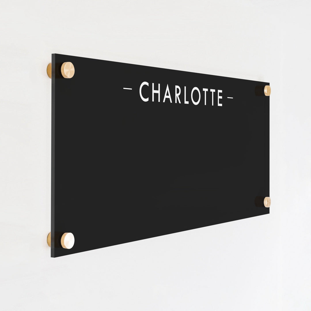 A dry-erase board made of clear acrylic with a custom title up top