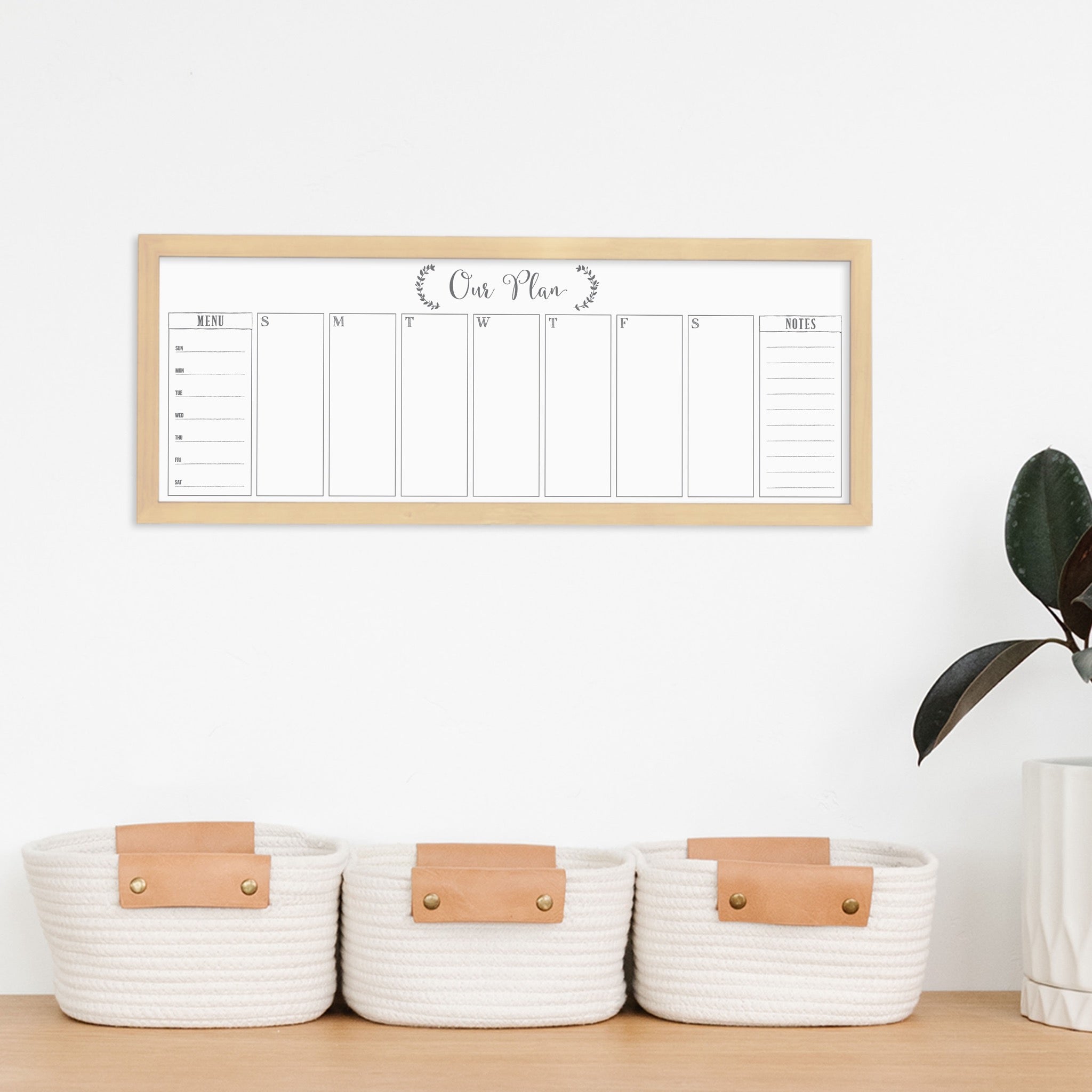 A framed slim whiteboard weekly calender hanging on the wall
