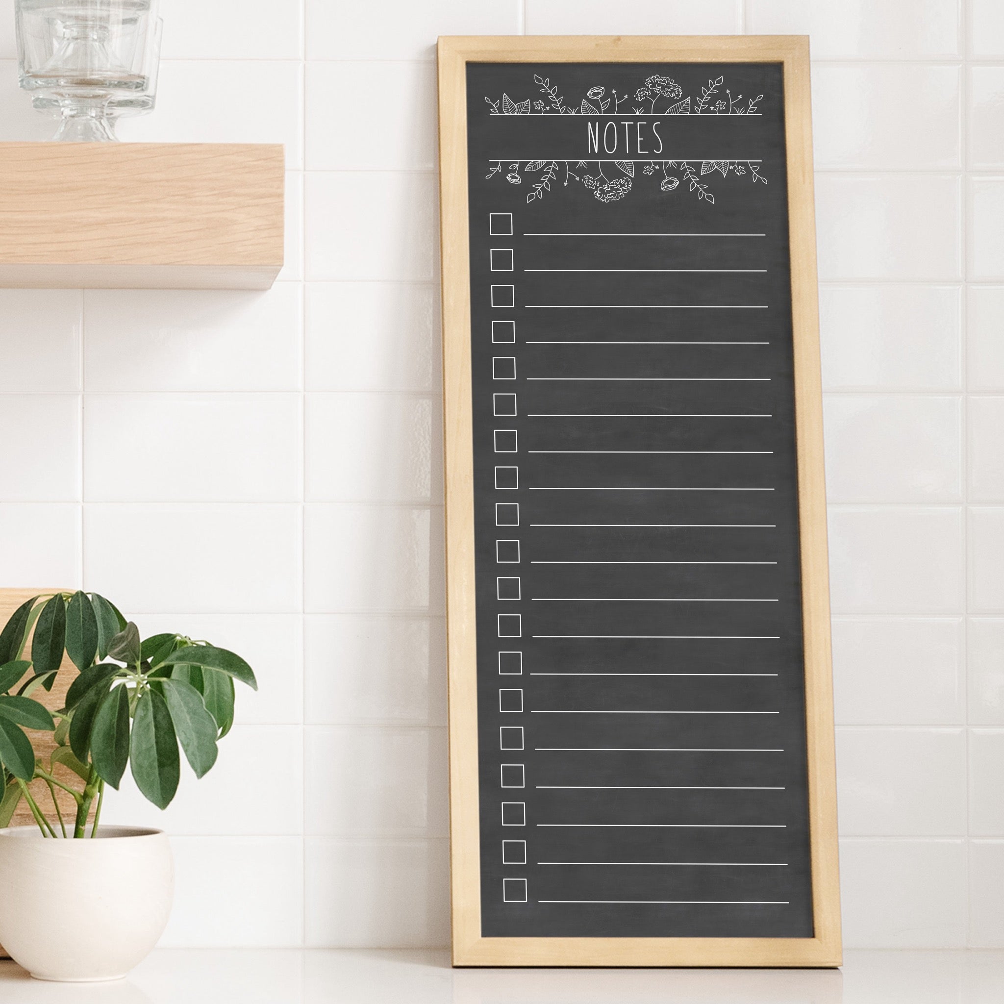 A framed dry-erase to do list with a chalkboard look hanging on the wall