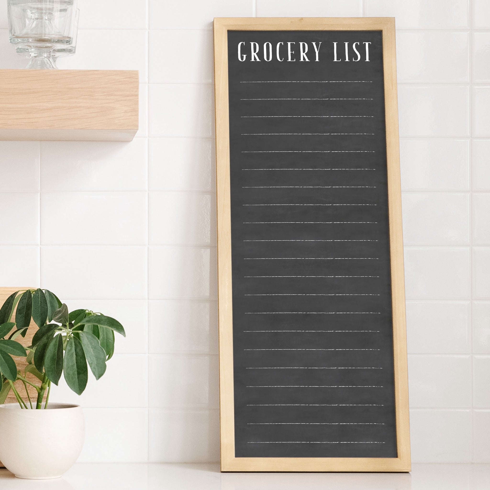 A framed dry-erase to do list with a chalkboard look hanging on the wall