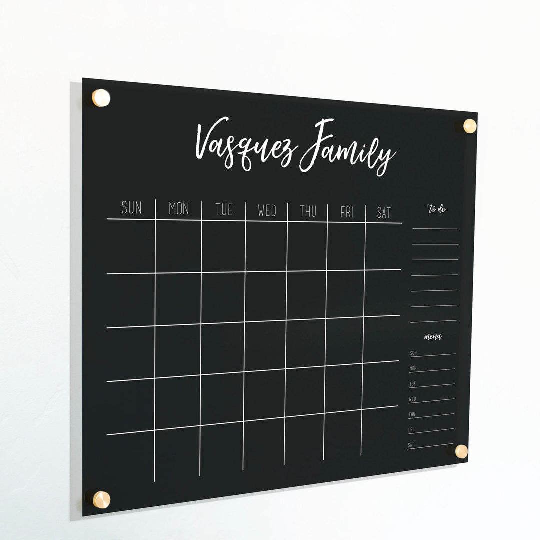 A Dry-erase monthly calender made of acrylic hanging on the wall