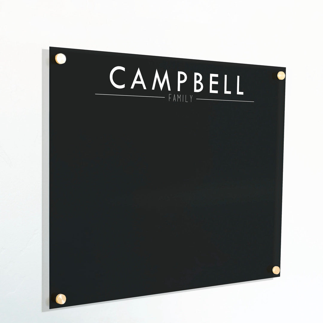 A dry-erase board made of clear acrylic with a custom title up top