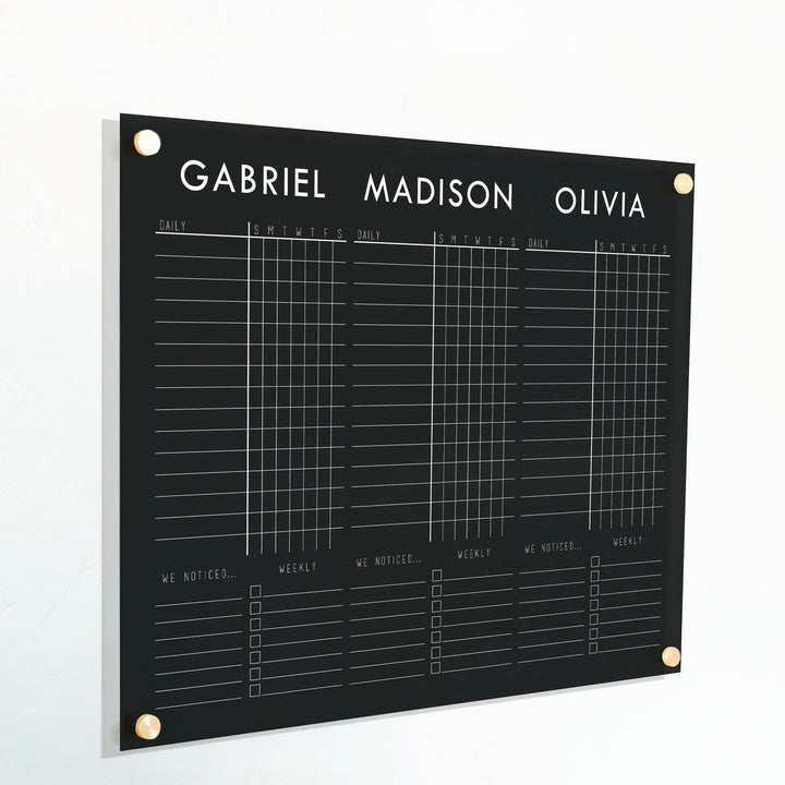 A Dry-erase acrylic chore chart hanging on the wall