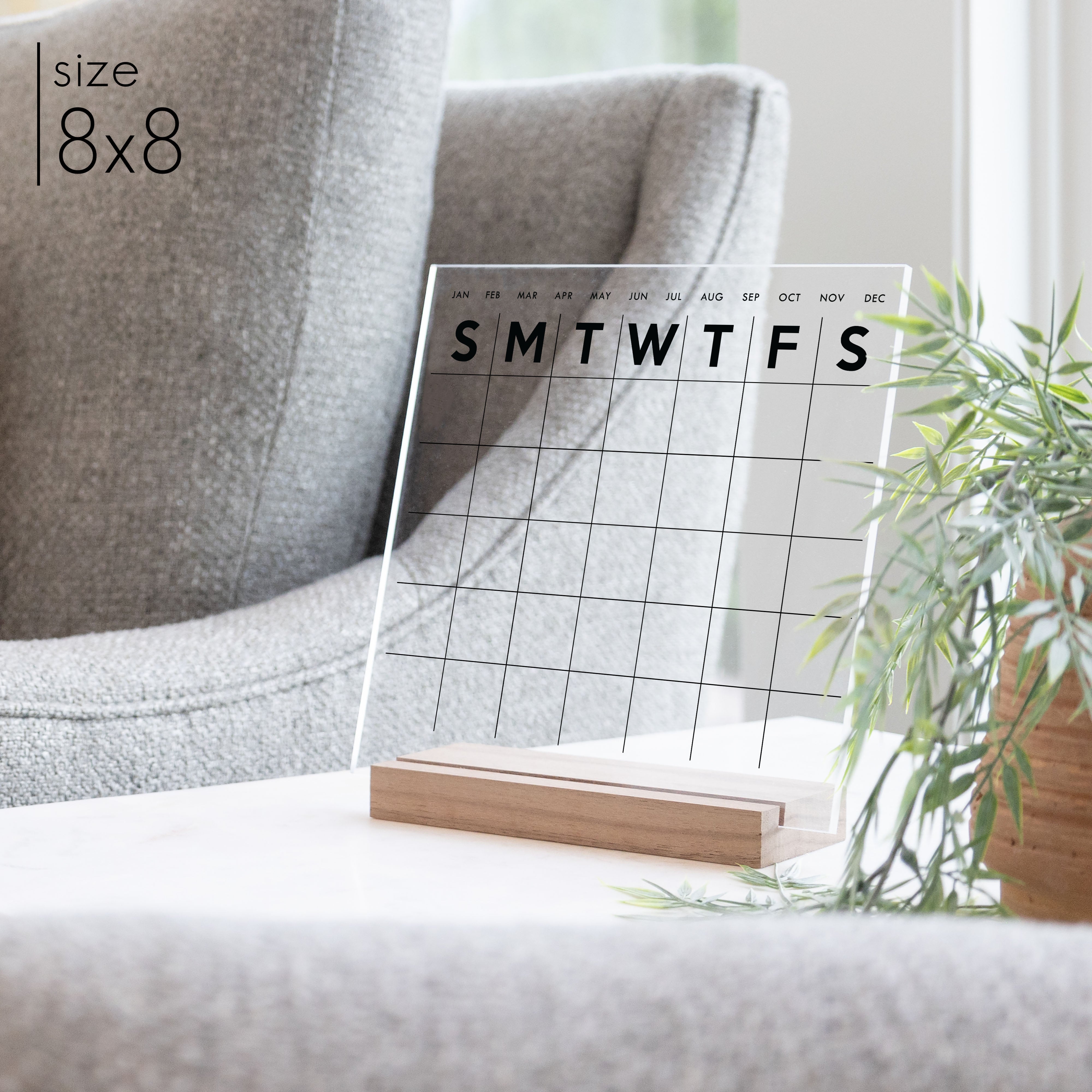 A simple calendar with months and days of the week displayed on a side table. 