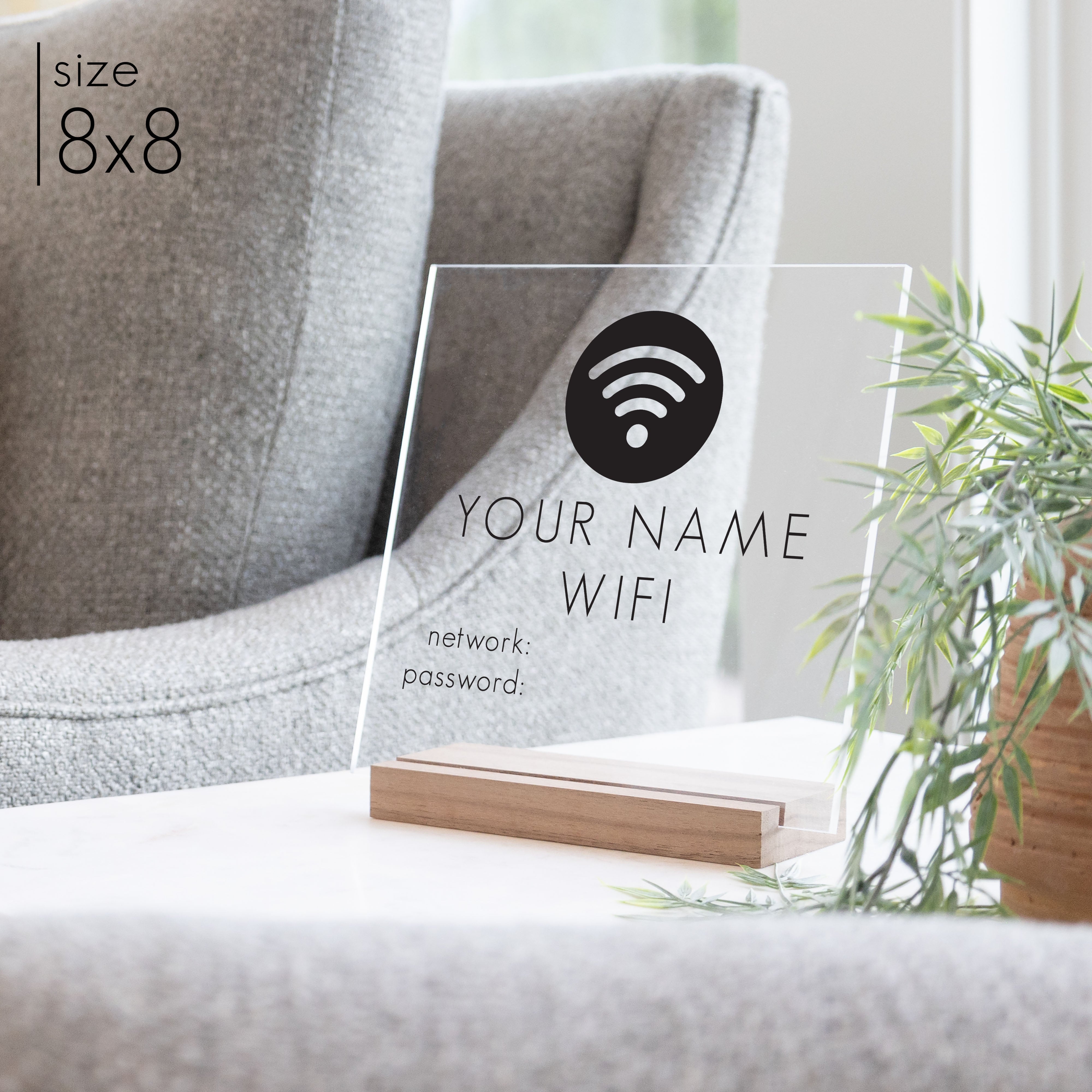 An 8x8 wifi password sign on a walnut stand in a living room