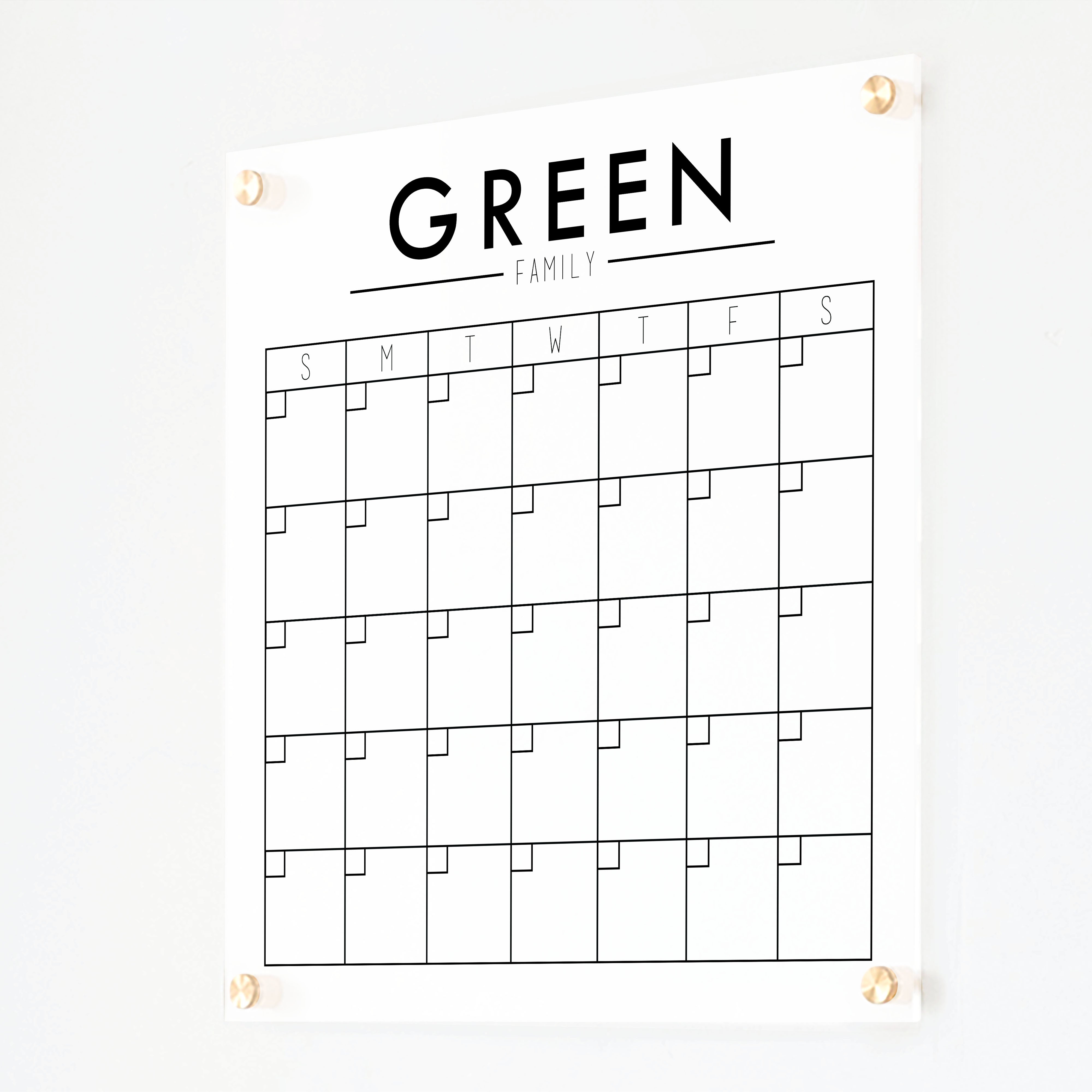 A Dry-erase monthly calender made of acrylic hanging on the wall