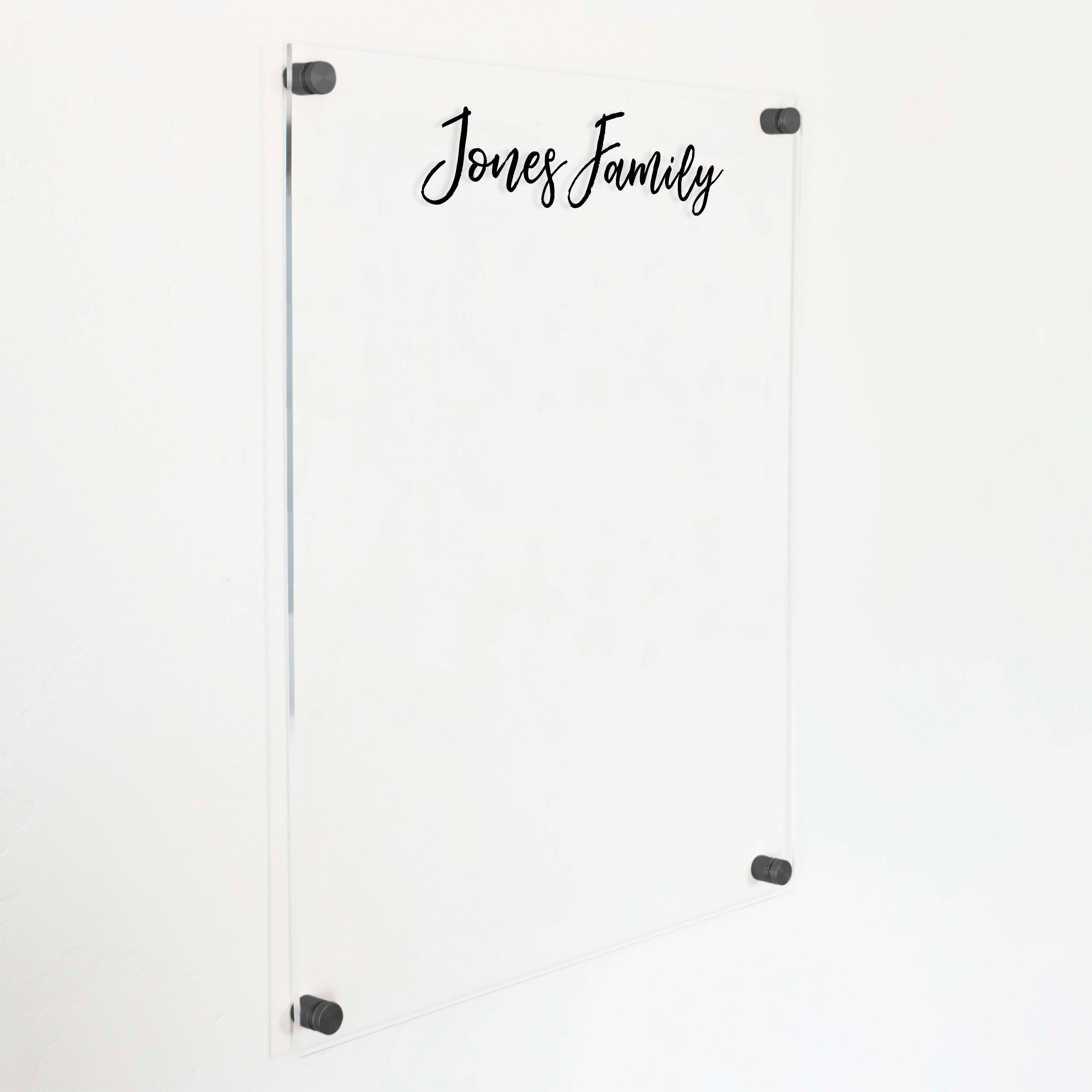 A dry-erase board made of clear acrylic with a custom title up top
