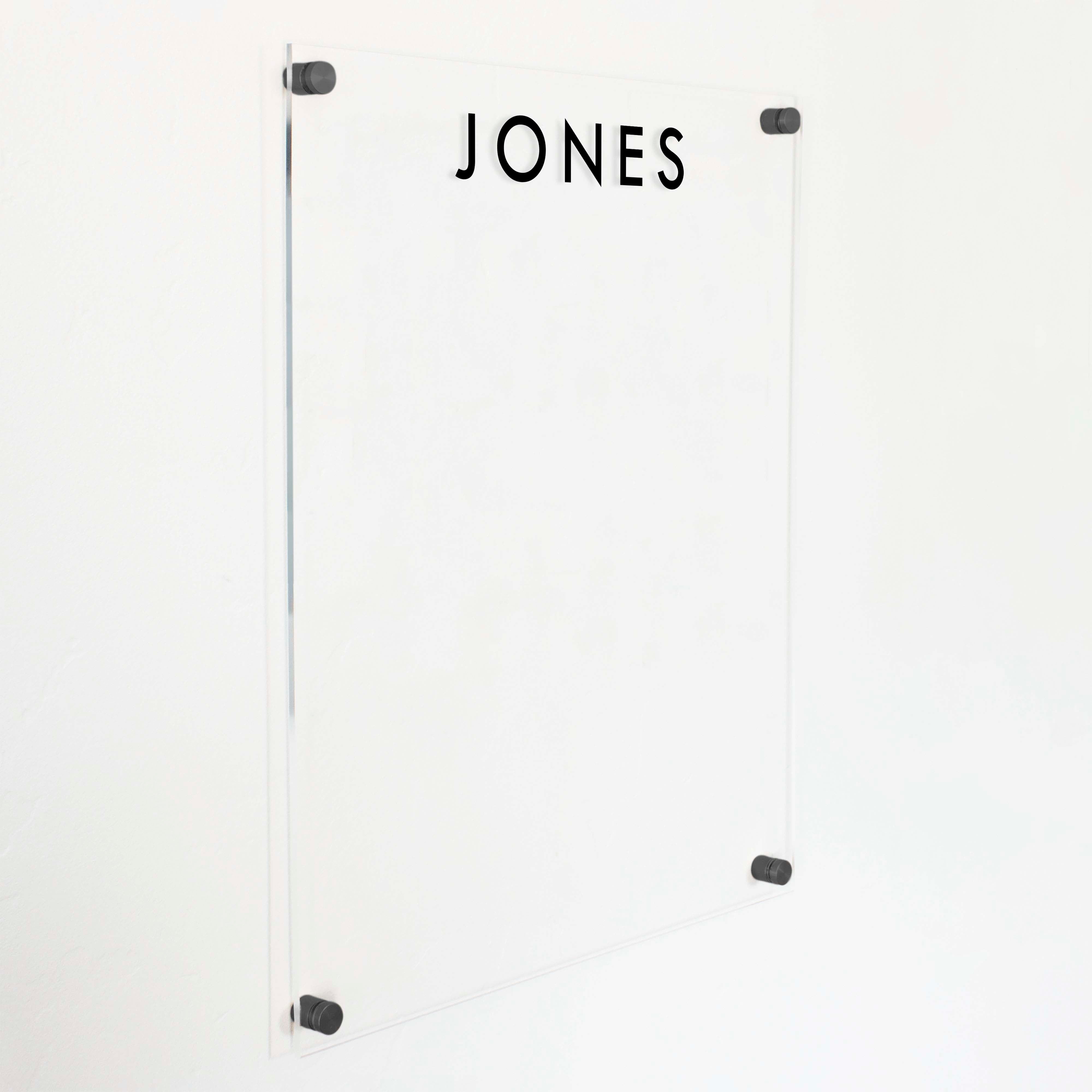 A dry-erase board made of clear acrylic with a custom title up top