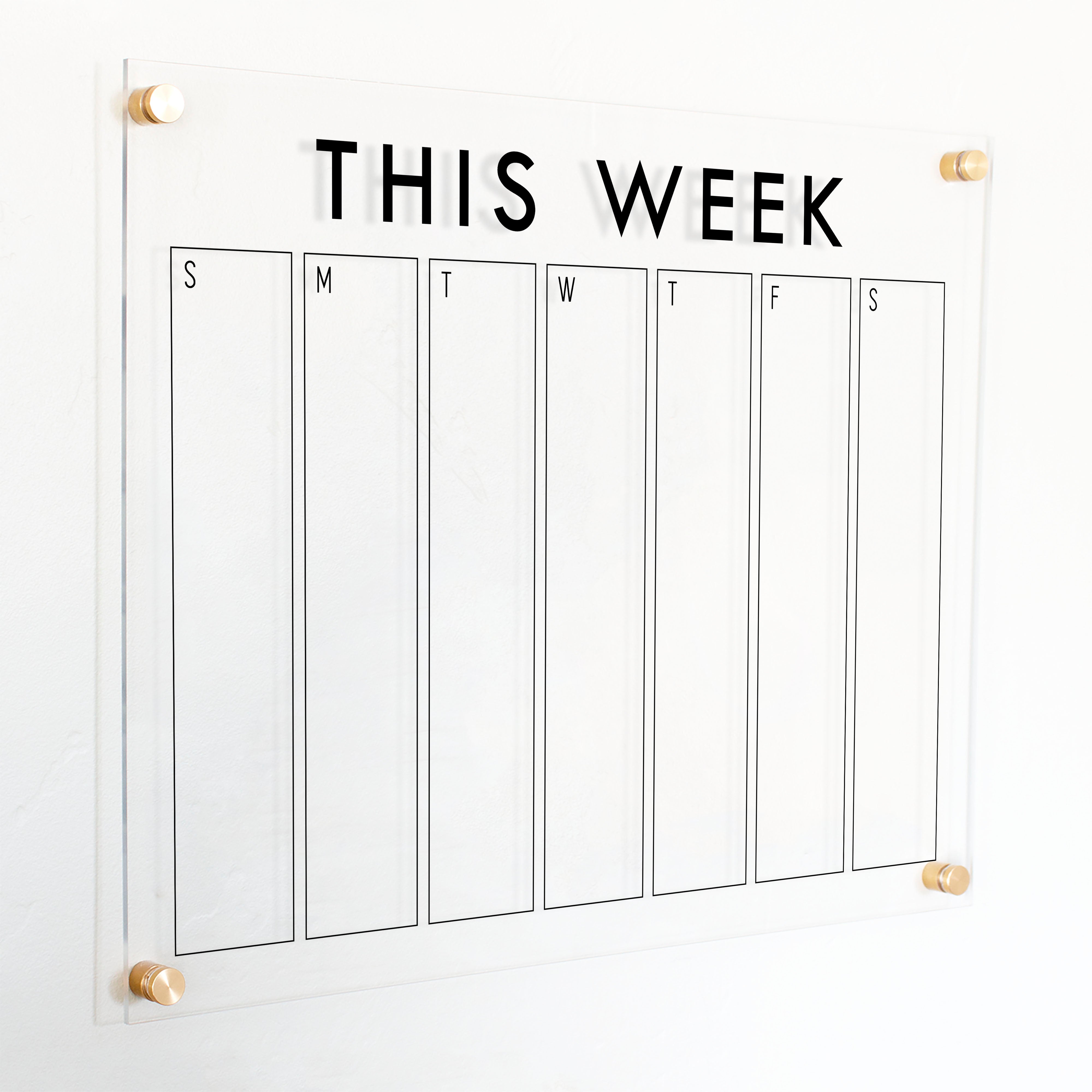 A Dry-erase weekly calender made of acrylic hanging on the wall