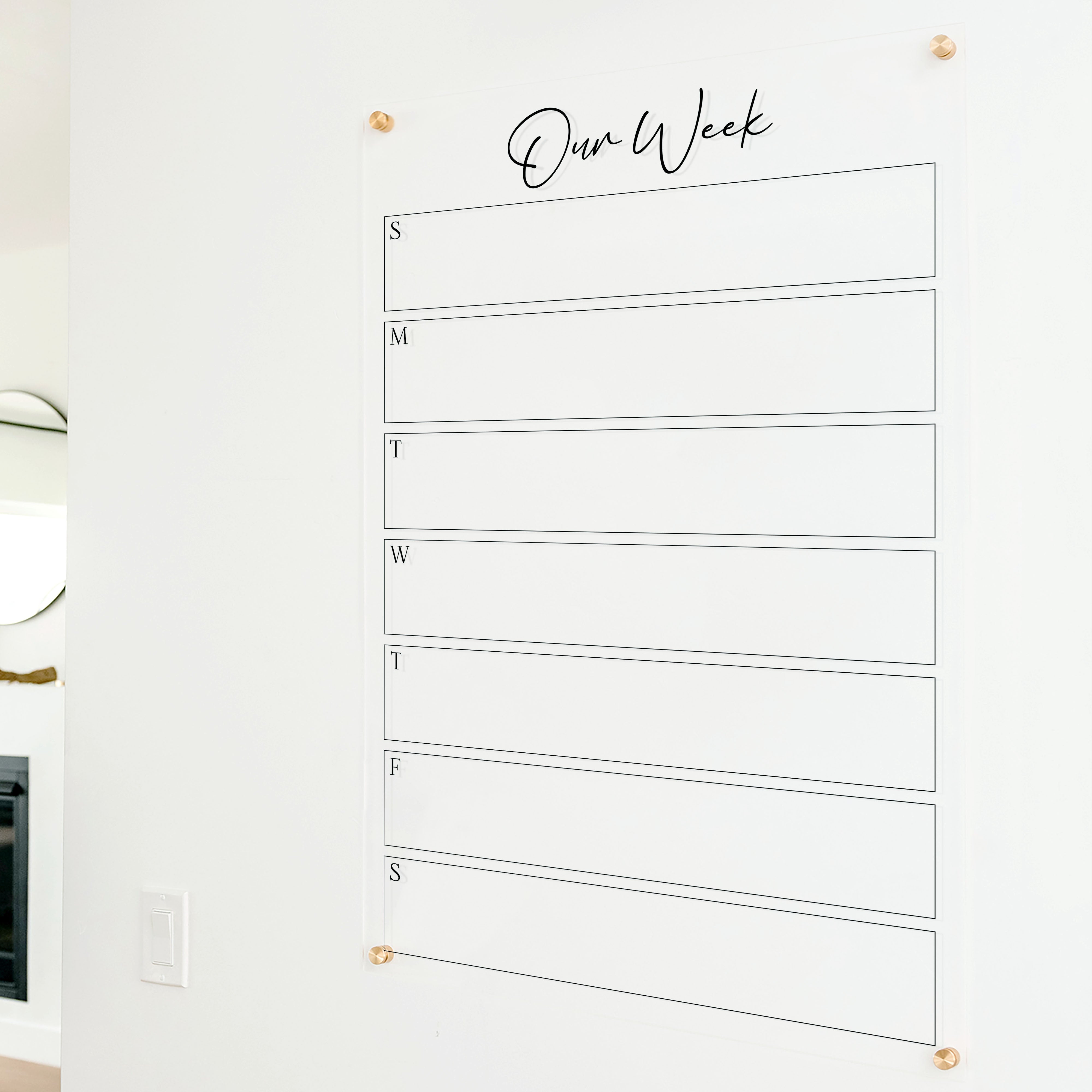A Dry-erase weekly calender made of acrylic hanging on the wall