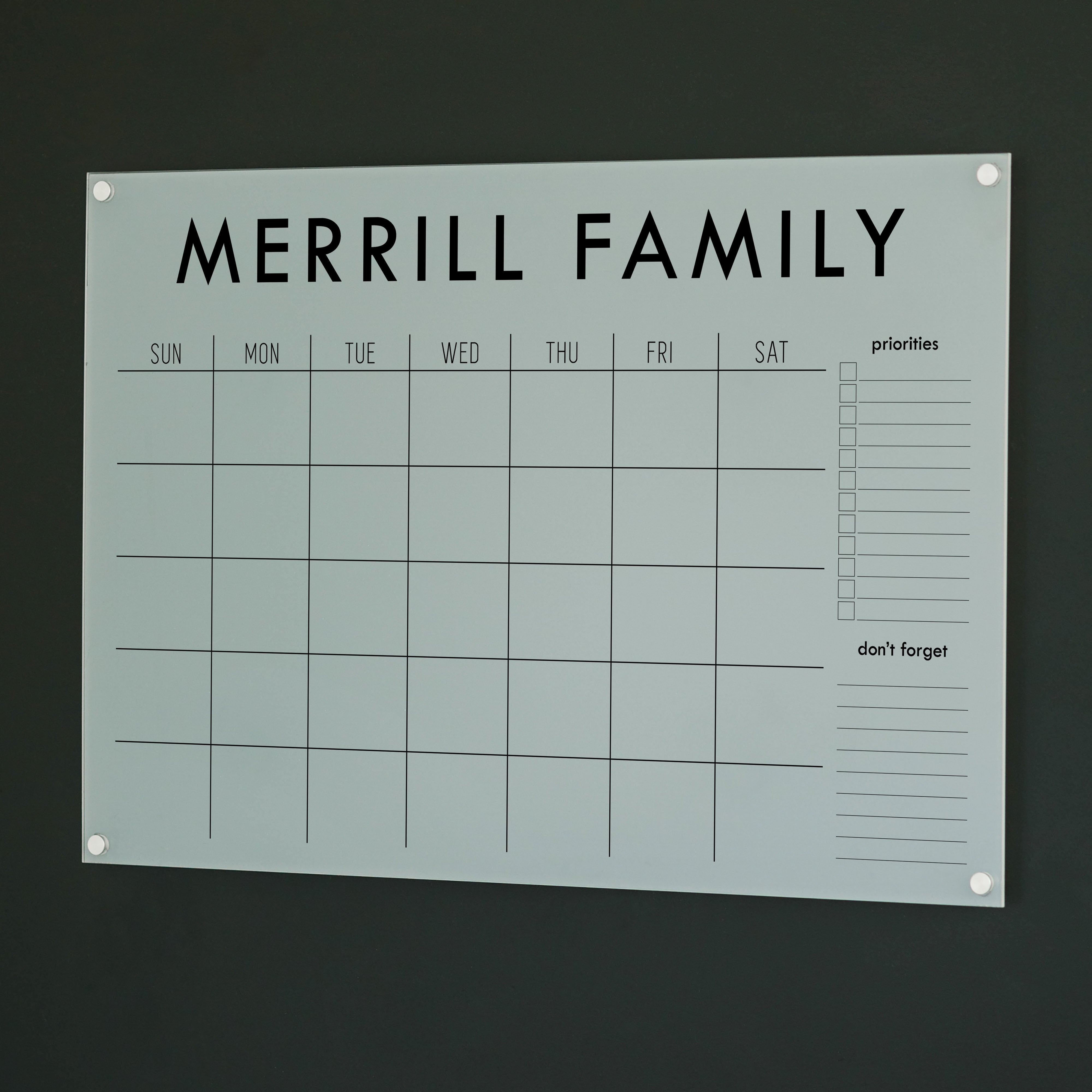 A Dry-erase monthly calender made of acrylic hanging on the wall