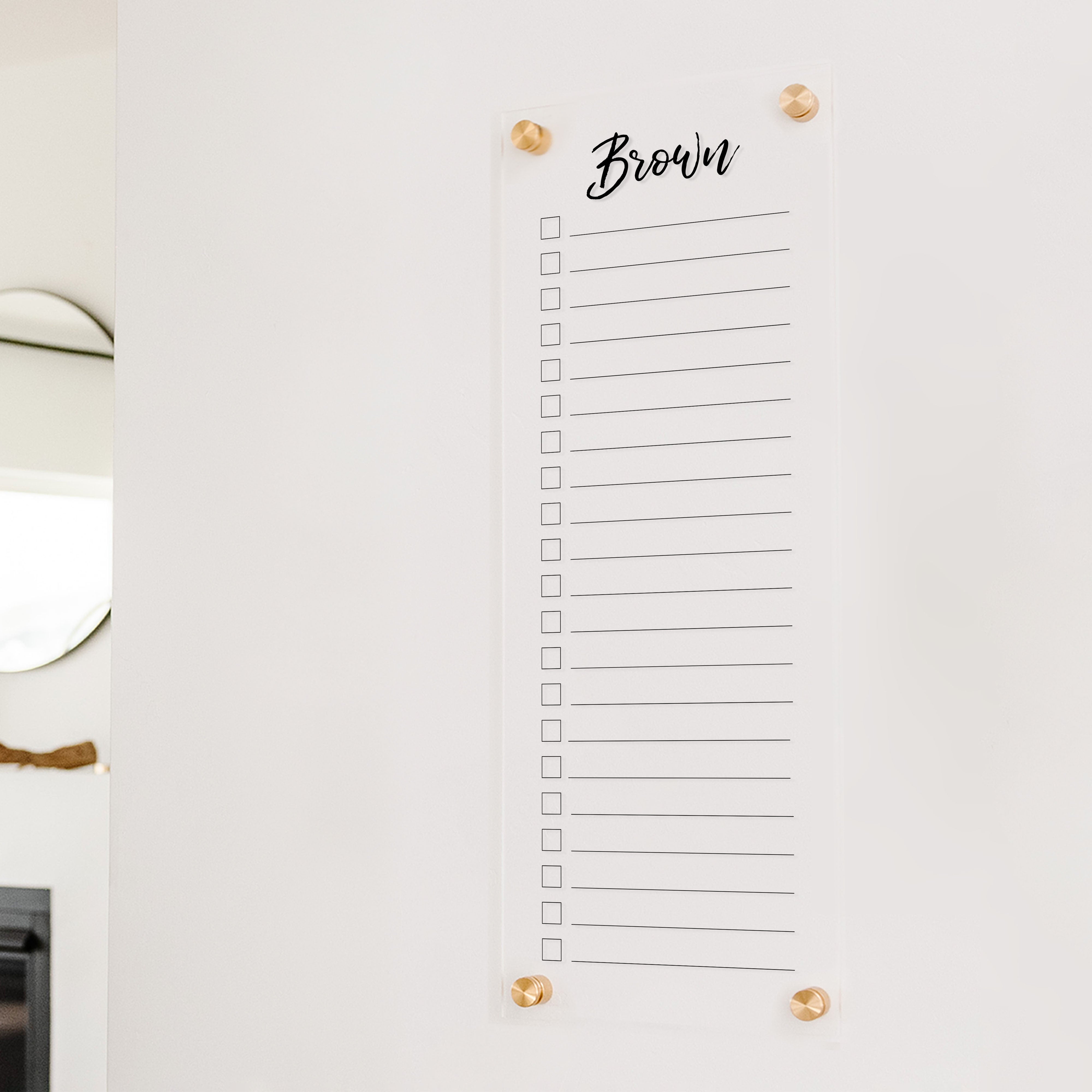 A dry-erase to do list made of acrylic hanging on the wall