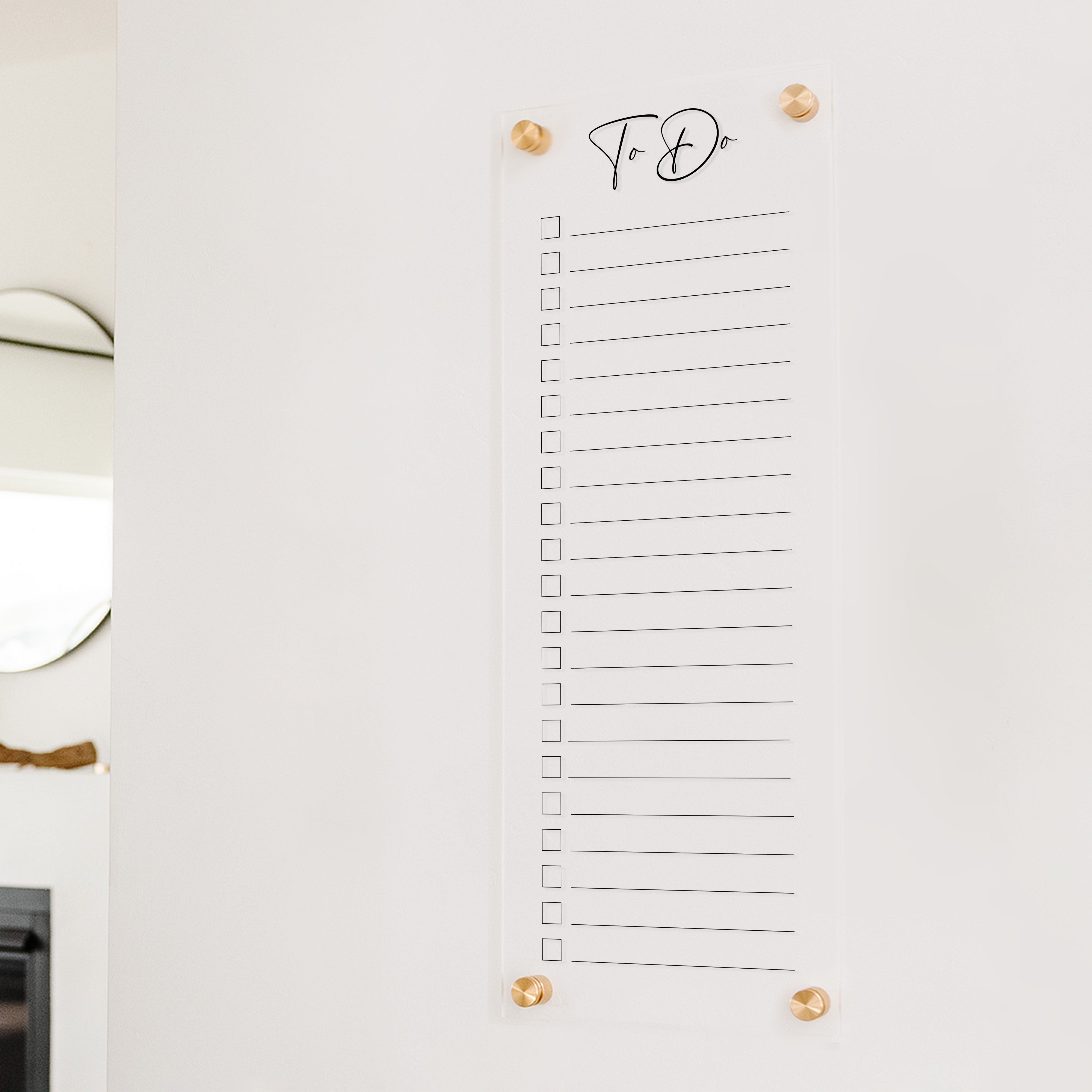 A dry-erase to do list made of acrylic hanging on the wall