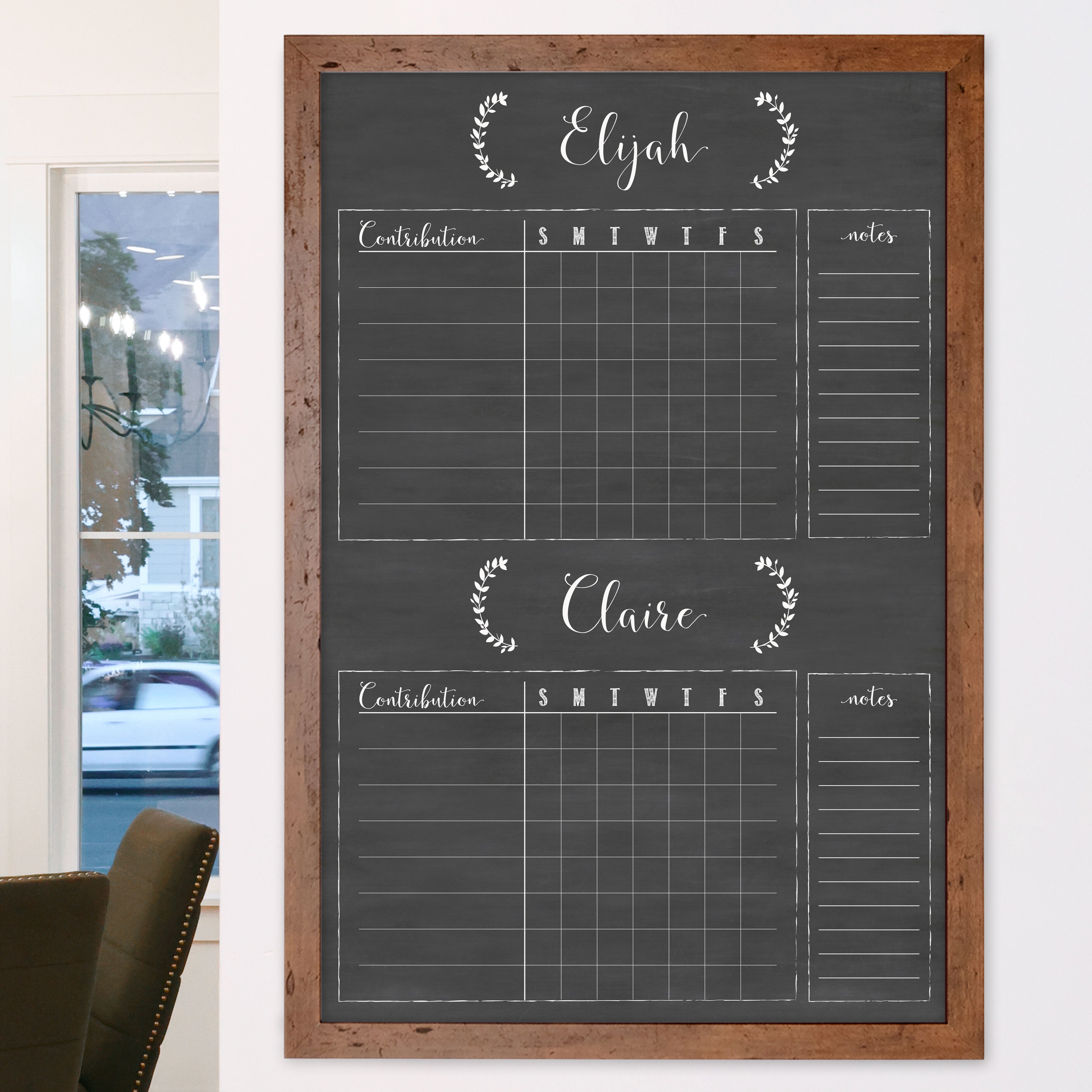 A framed dry-erase chore chart with a chalkboard look hanging on the wall