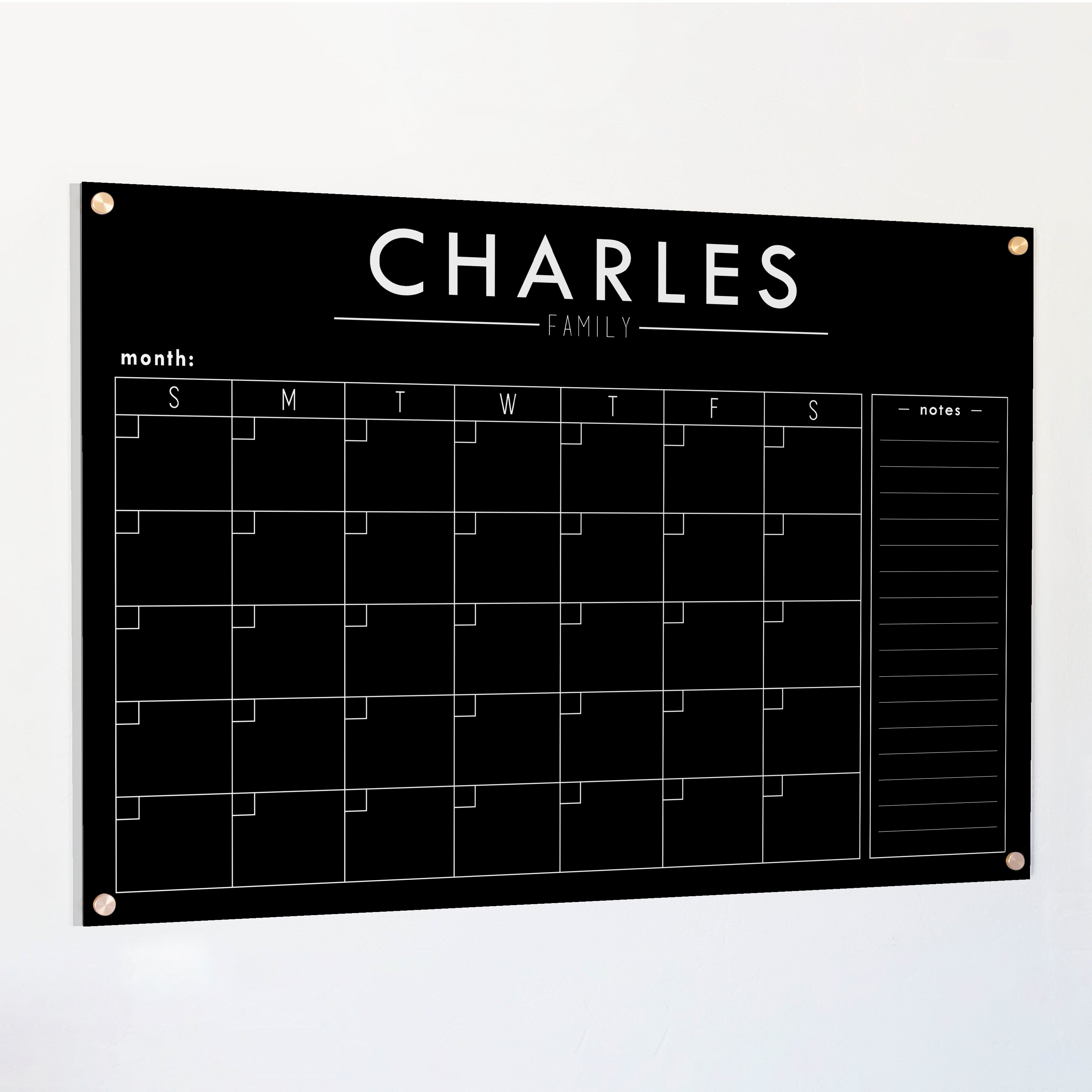 A Dry-erase monthly calender made of acrylic hanging on the wall