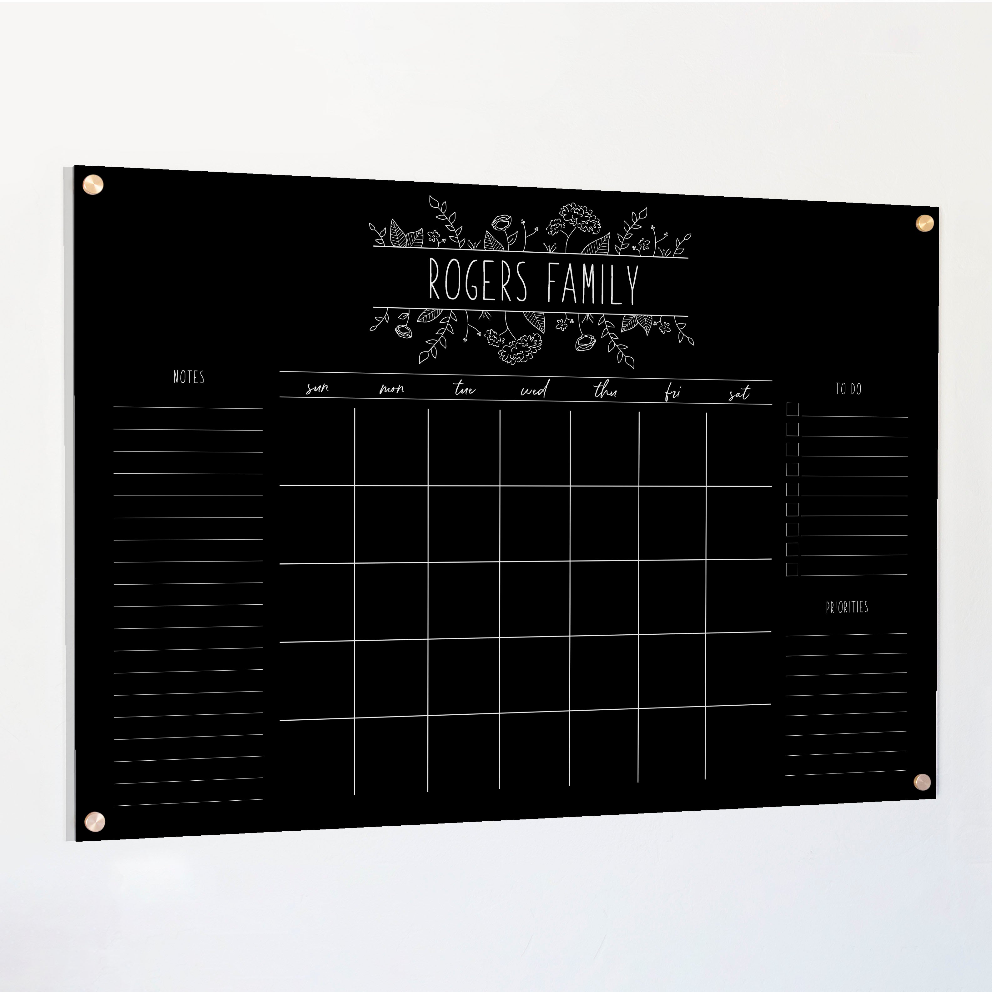 A Dry-erase monthly calender made of acrylic hanging on the wall