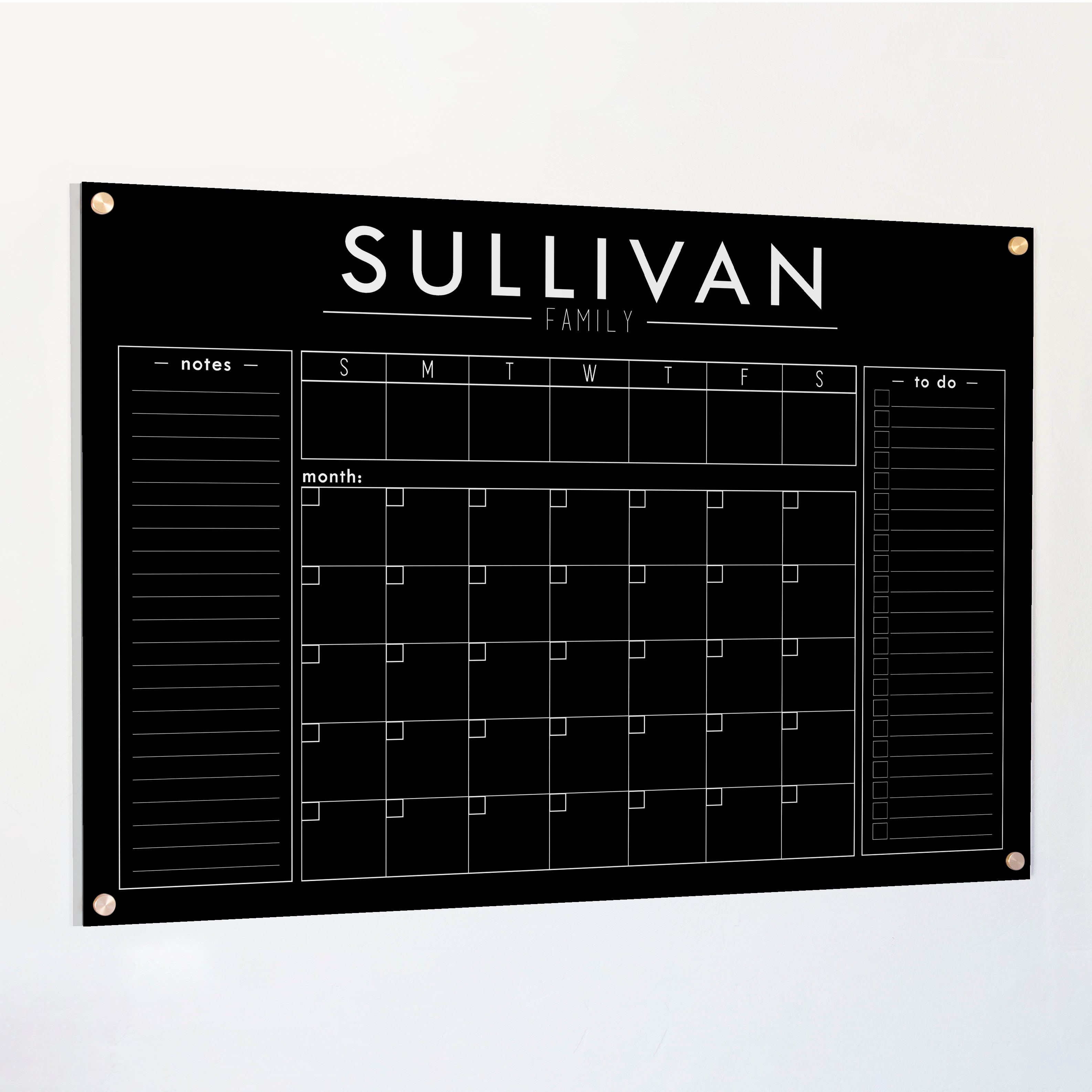 A Dry-erase calendar with a monthly and weekly format made of acrylic hanging on the wall