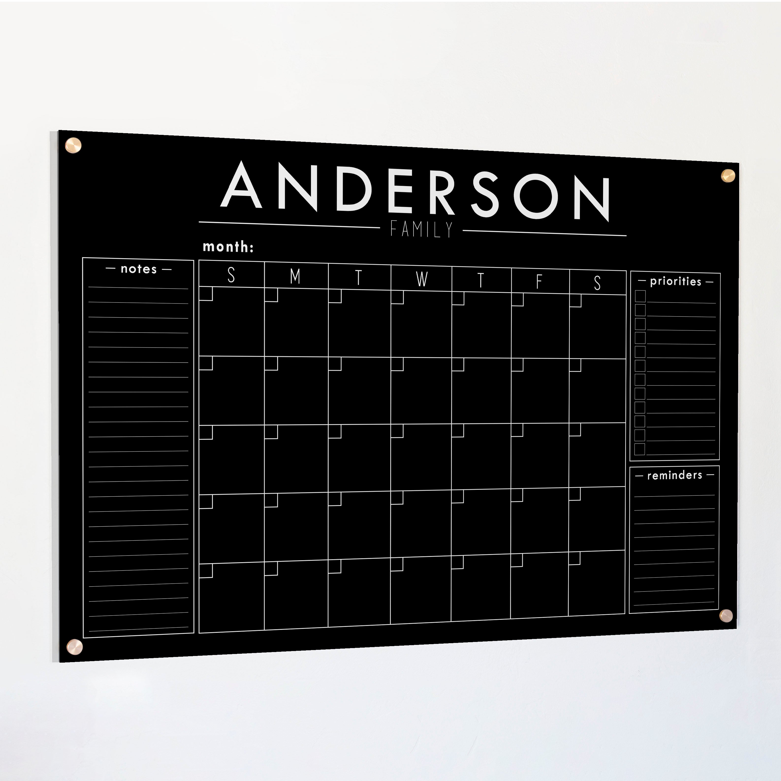 A Dry-erase monthly calender made of acrylic hanging on the wall