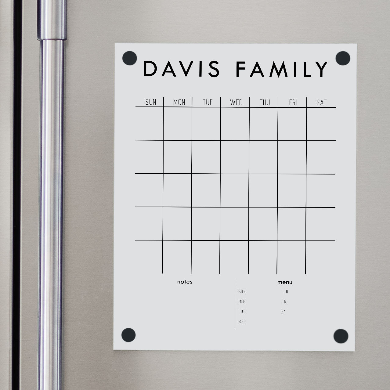 A Dry-erase monthly calender made of acrylic hanging on the fridge