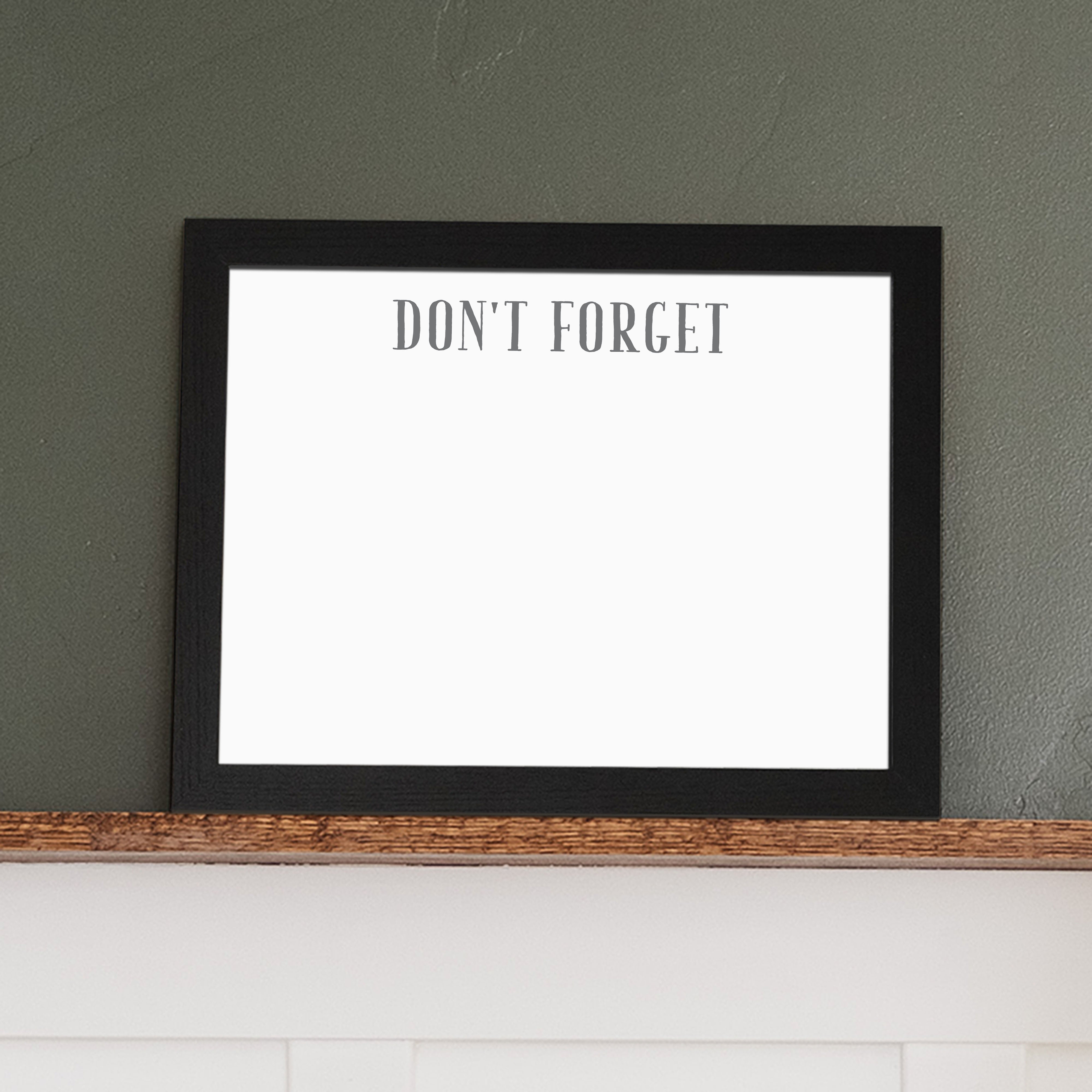 A framed whiteboard calendar with a two month design format hanging on the wall