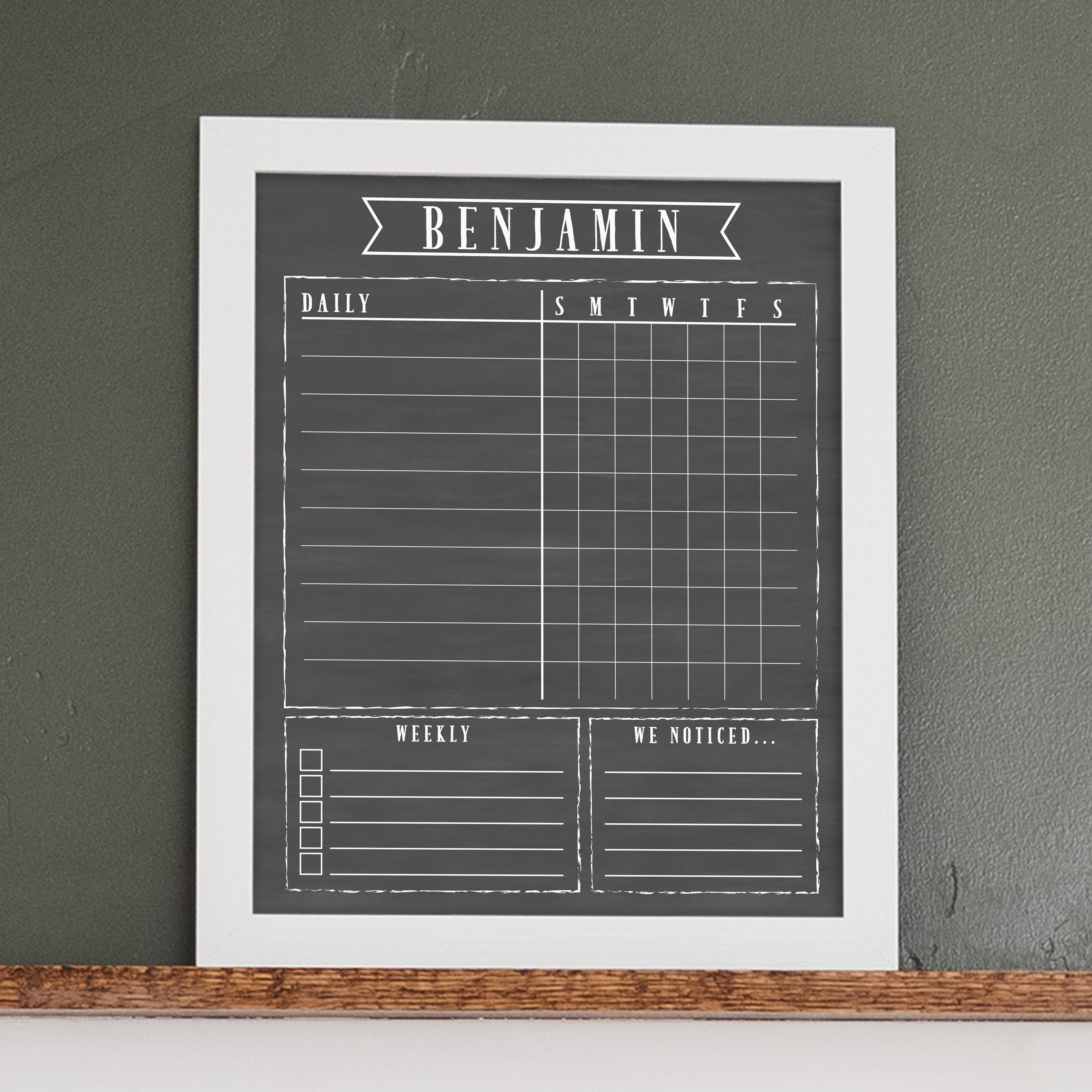 A framed dry-erase chore chart with a chalkboard look hanging on the wall
