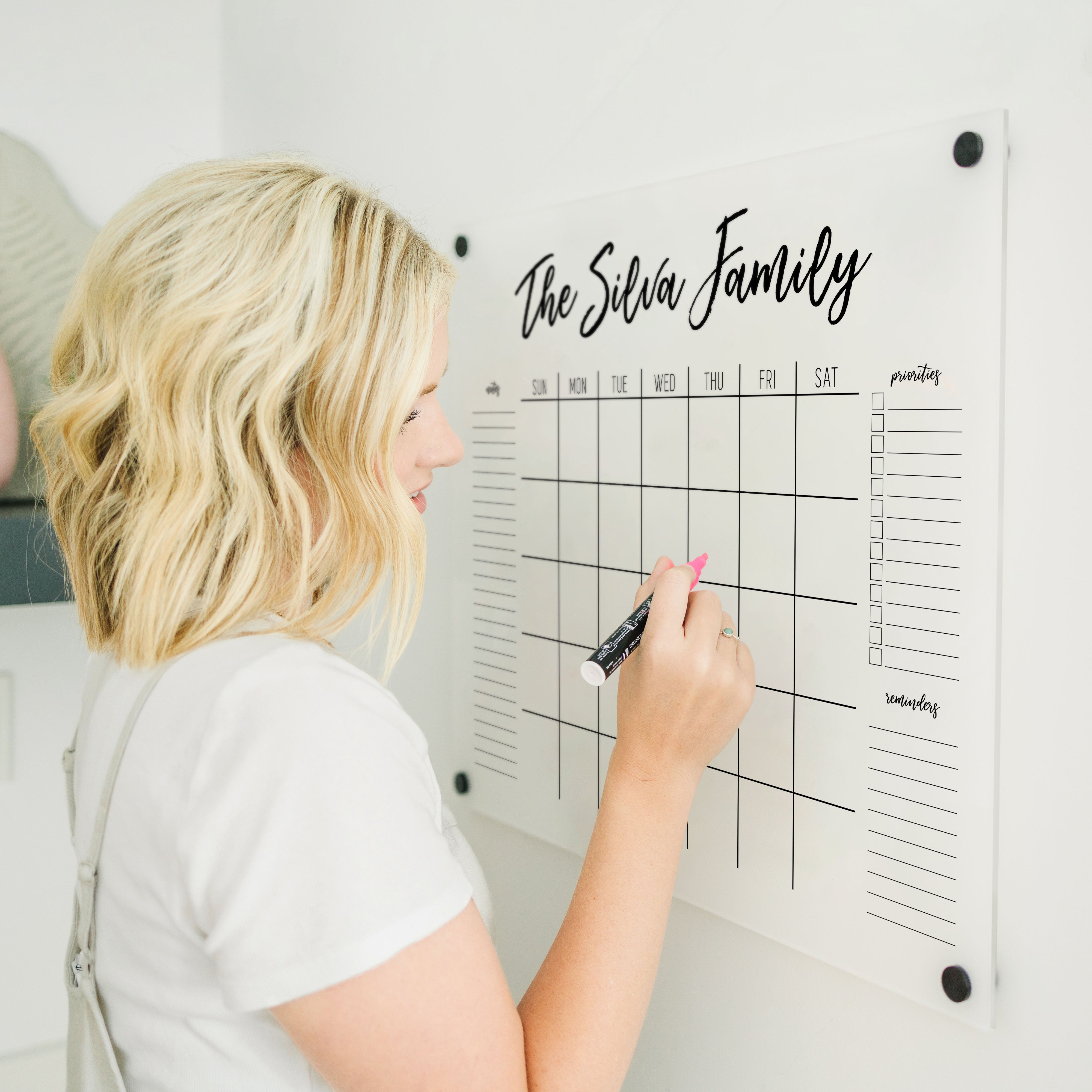 A Dry-erase monthly calender made of acrylic hanging on the wall